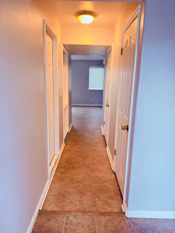 Corridor featuring baseboards