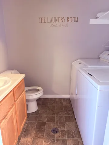 Bathroom featuring vanity and washer and dryer