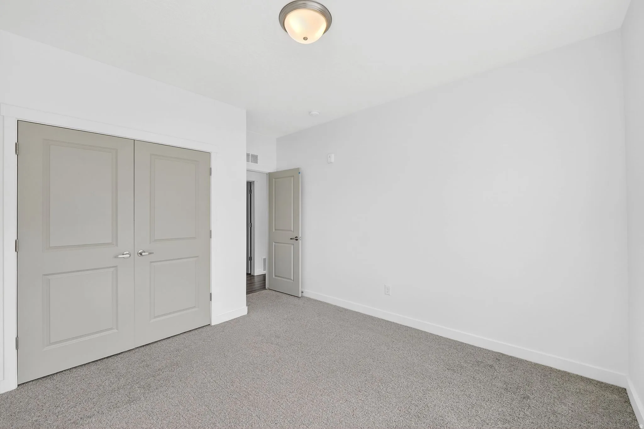 Unfurnished bedroom featuring carpet flooring and a closet