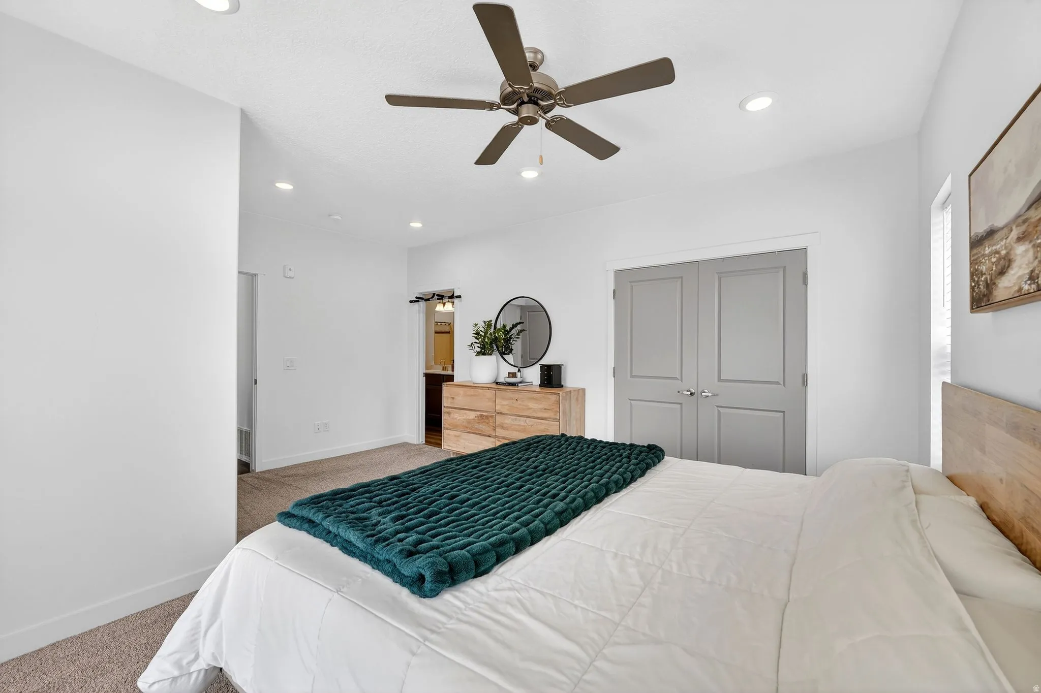 Bedroom with carpet, ceiling fan, recessed lighting, and a closet