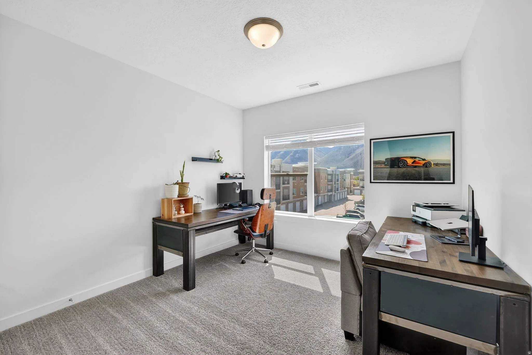 Home office featuring light colored carpet and baseboards