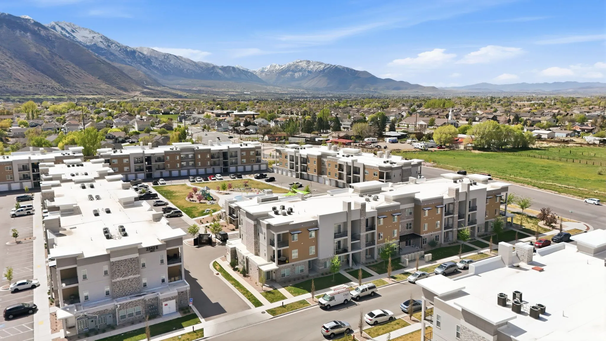 Drone / aerial view of a mountainous background and apartment complex
