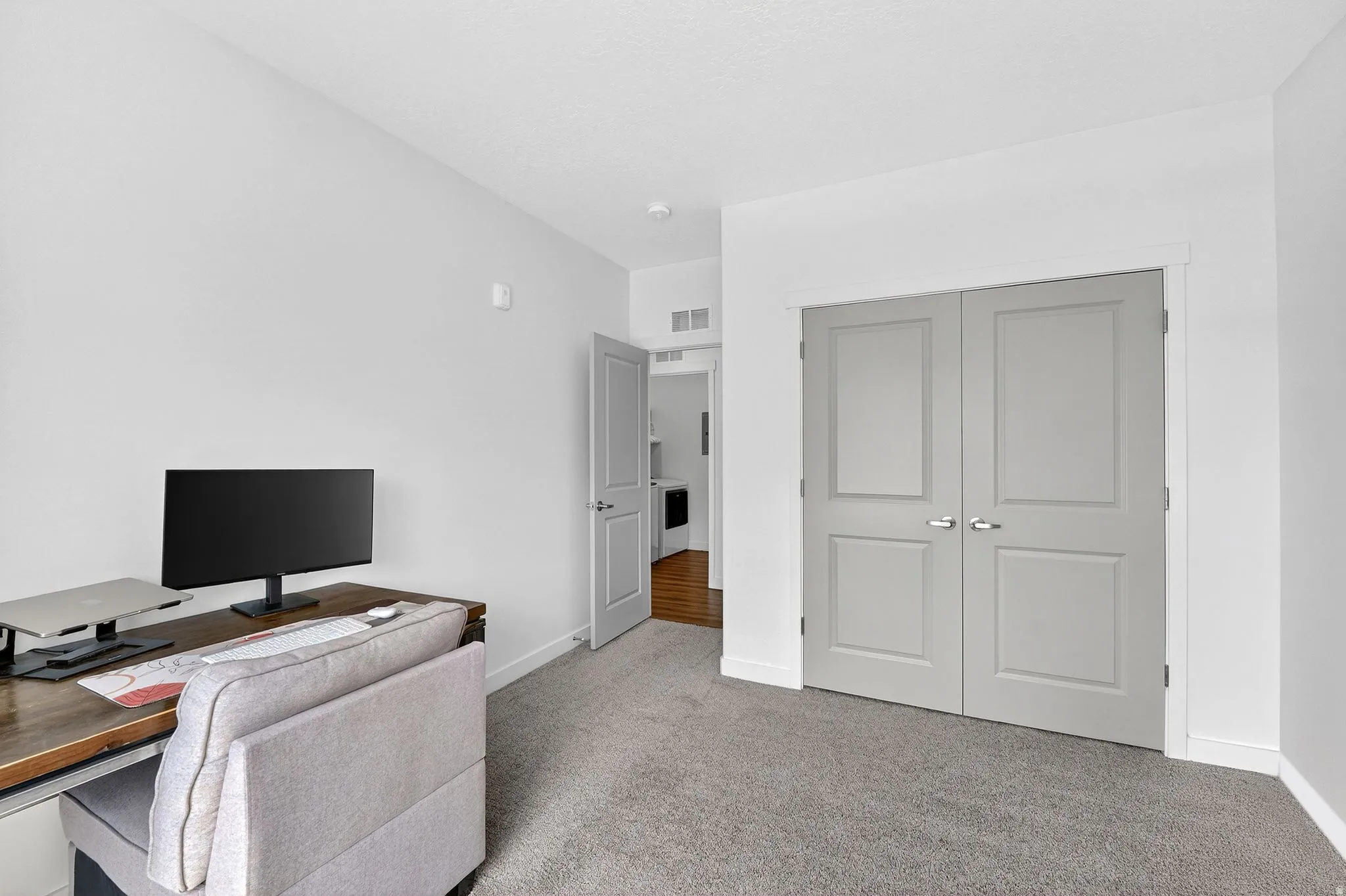 Office space featuring light carpet and baseboards