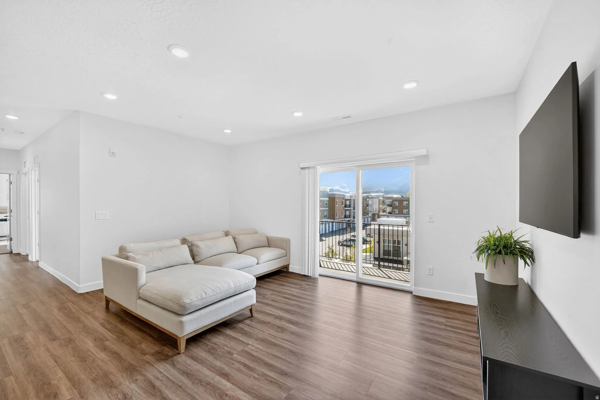 Living room with wood finished floors and recessed lighting