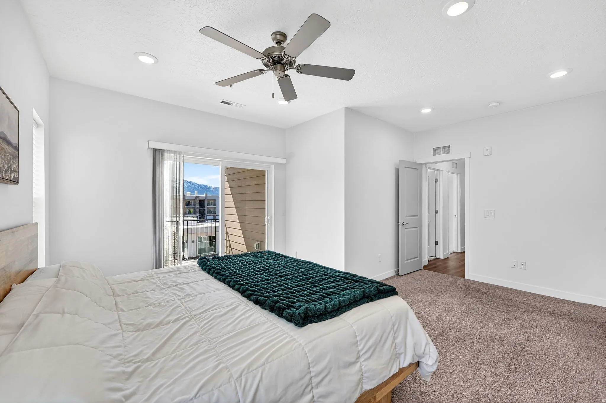 Carpeted bedroom with access to exterior, ceiling fan, and recessed lighting