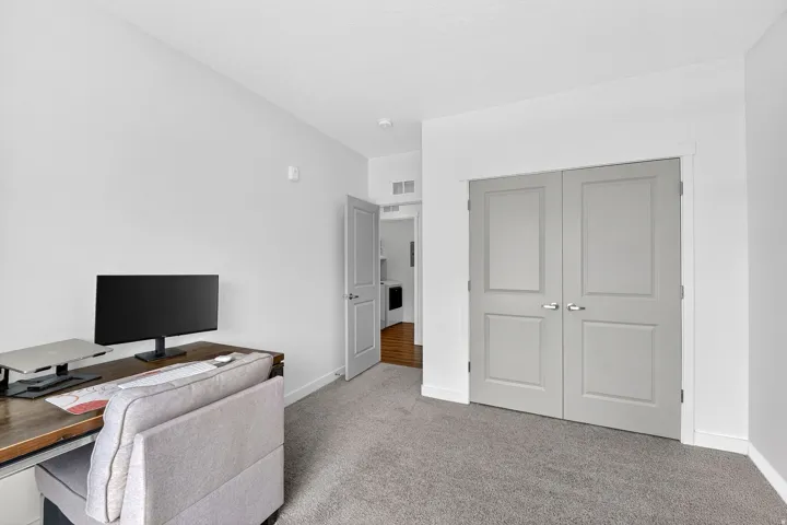 Office space featuring light carpet and baseboards
