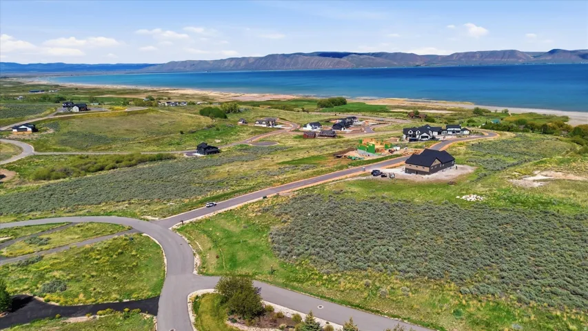 Expansive land parcel featuring existing paved roads and surrounding natural landscape