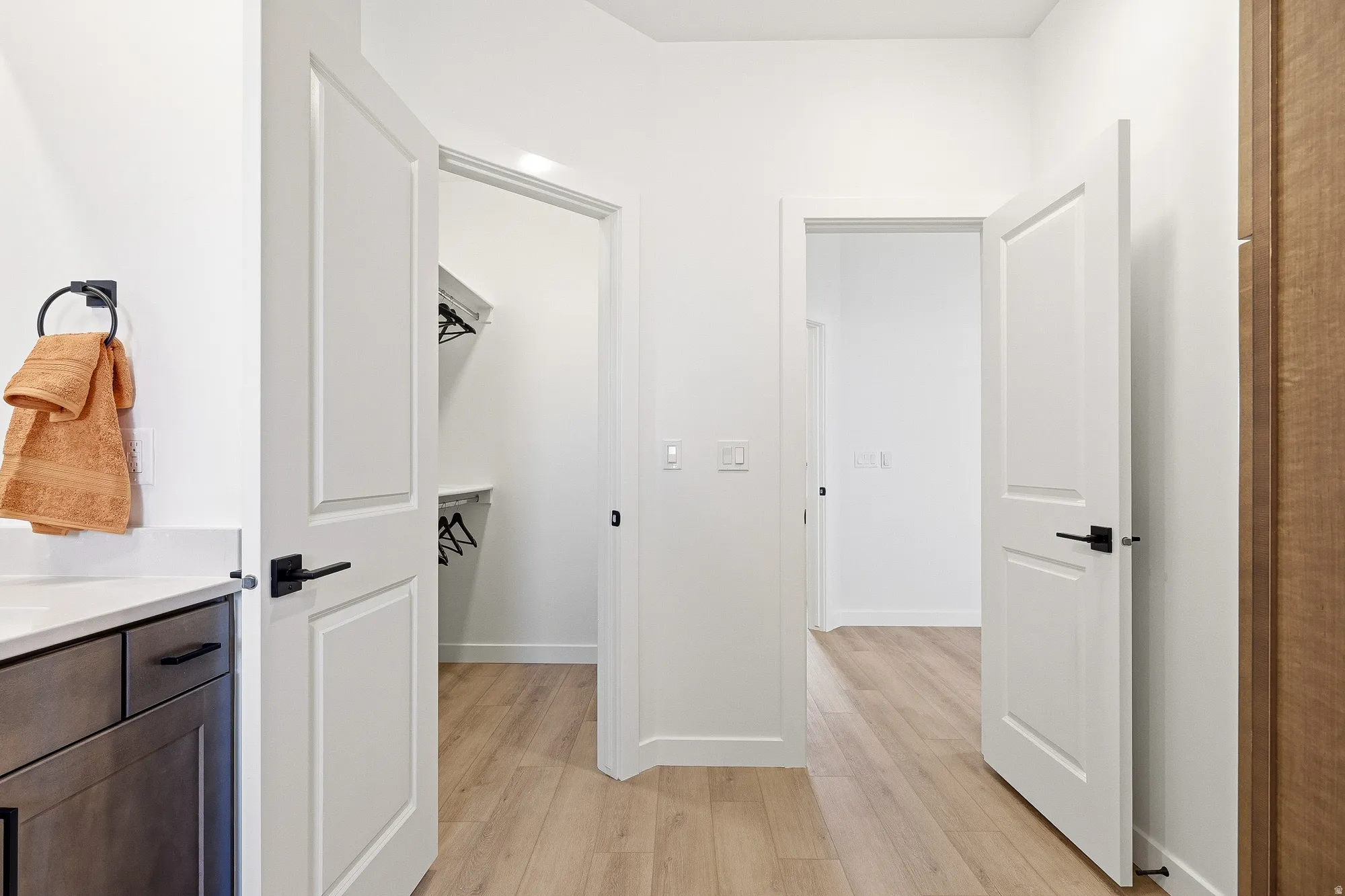 Corridor featuring light wood finished floors and baseboards