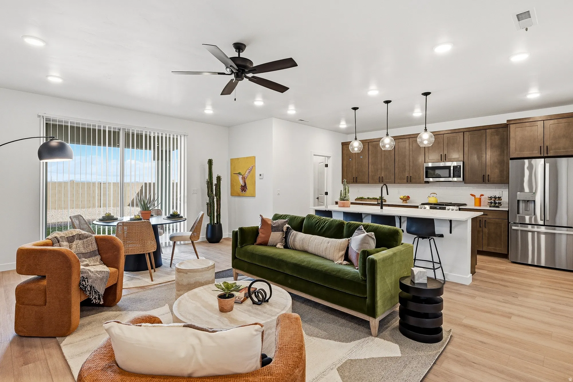 Living area featuring a ceiling fan, light wood finished floors, and recessed lighting