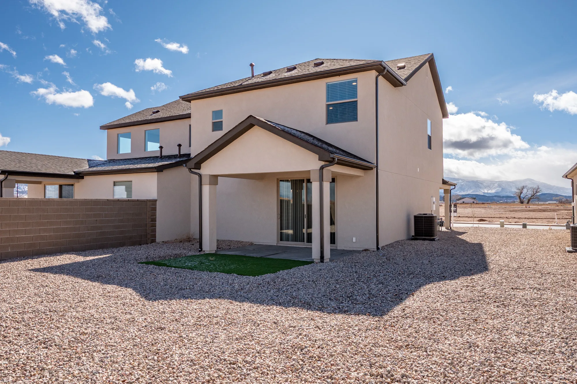 Back of house with a patio area, a fenced backyard, stucco siding, and a mountain view
