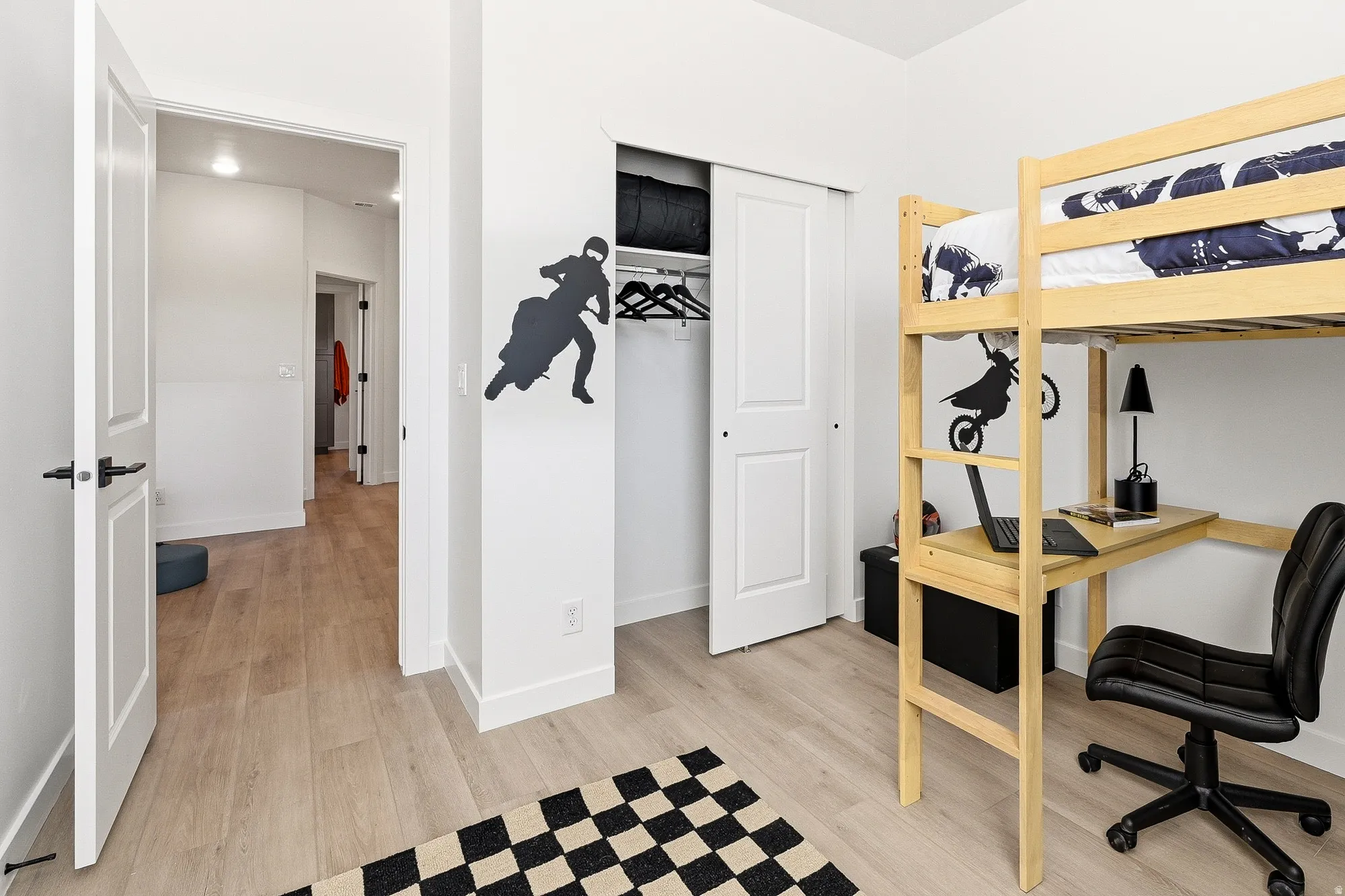 Bedroom with light wood-type flooring and a closet