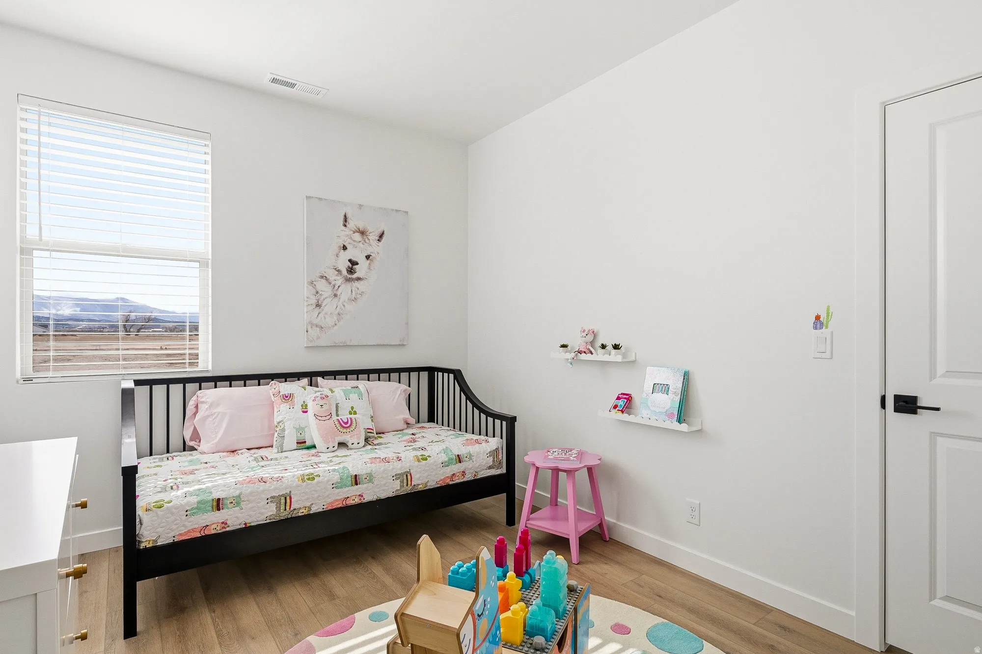 Bedroom with light wood-type flooring and baseboards
