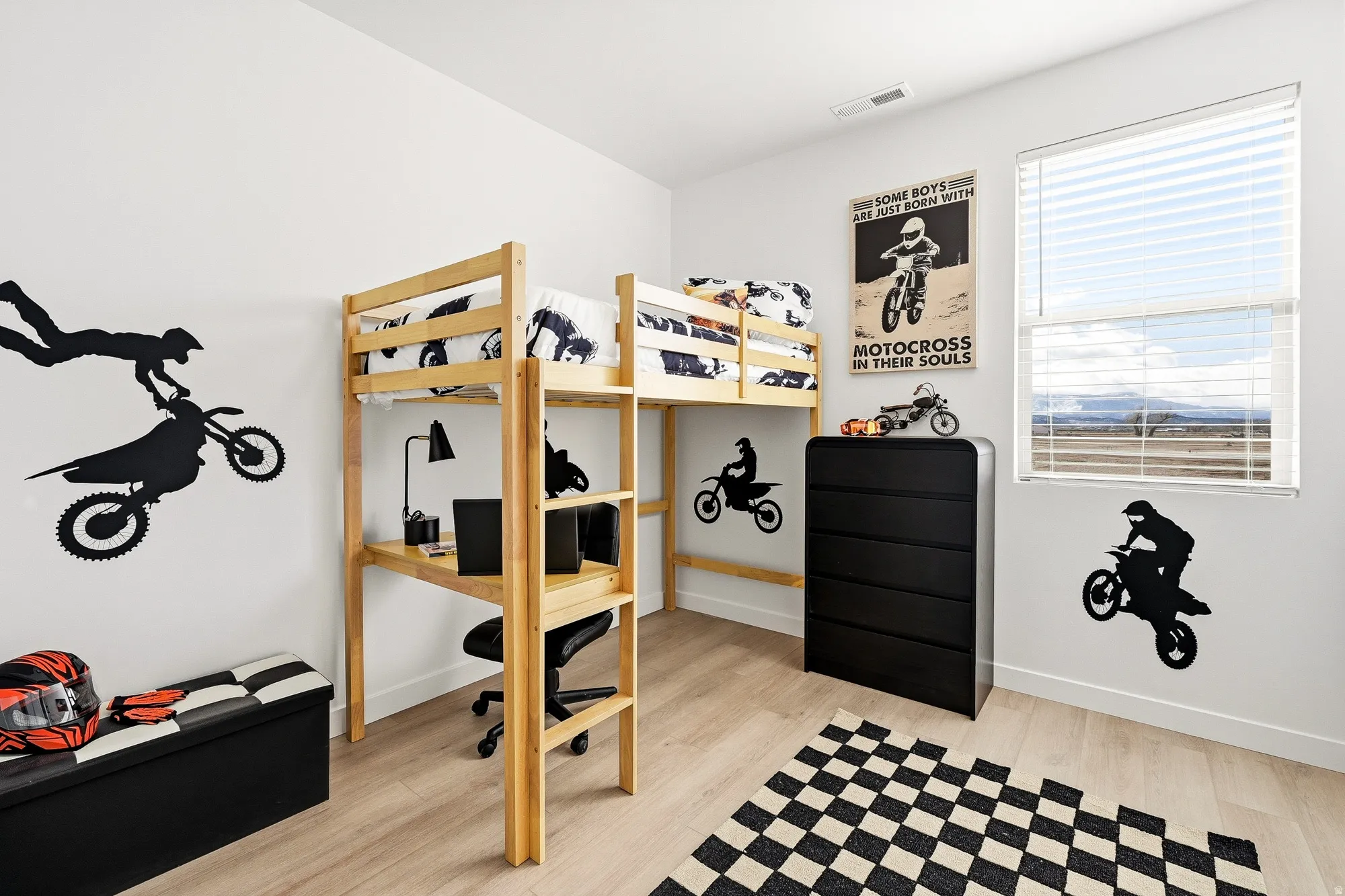Bedroom with light wood-style flooring and baseboards
