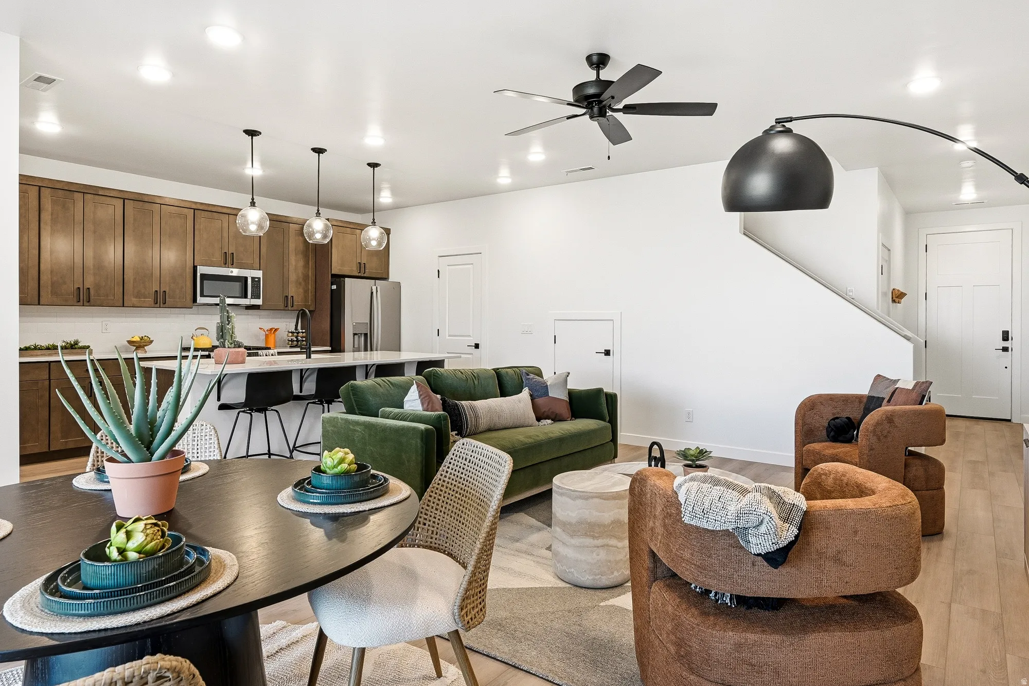 Living area featuring ceiling fan, light wood-type flooring, and recessed lighting