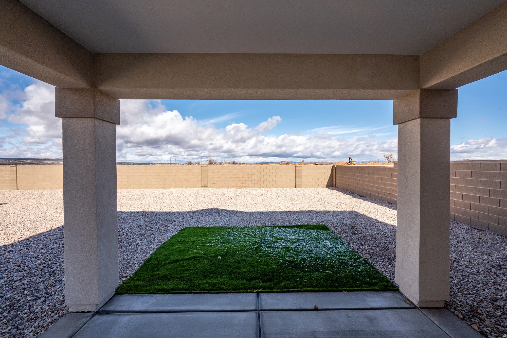 Fenced backyard with a patio area