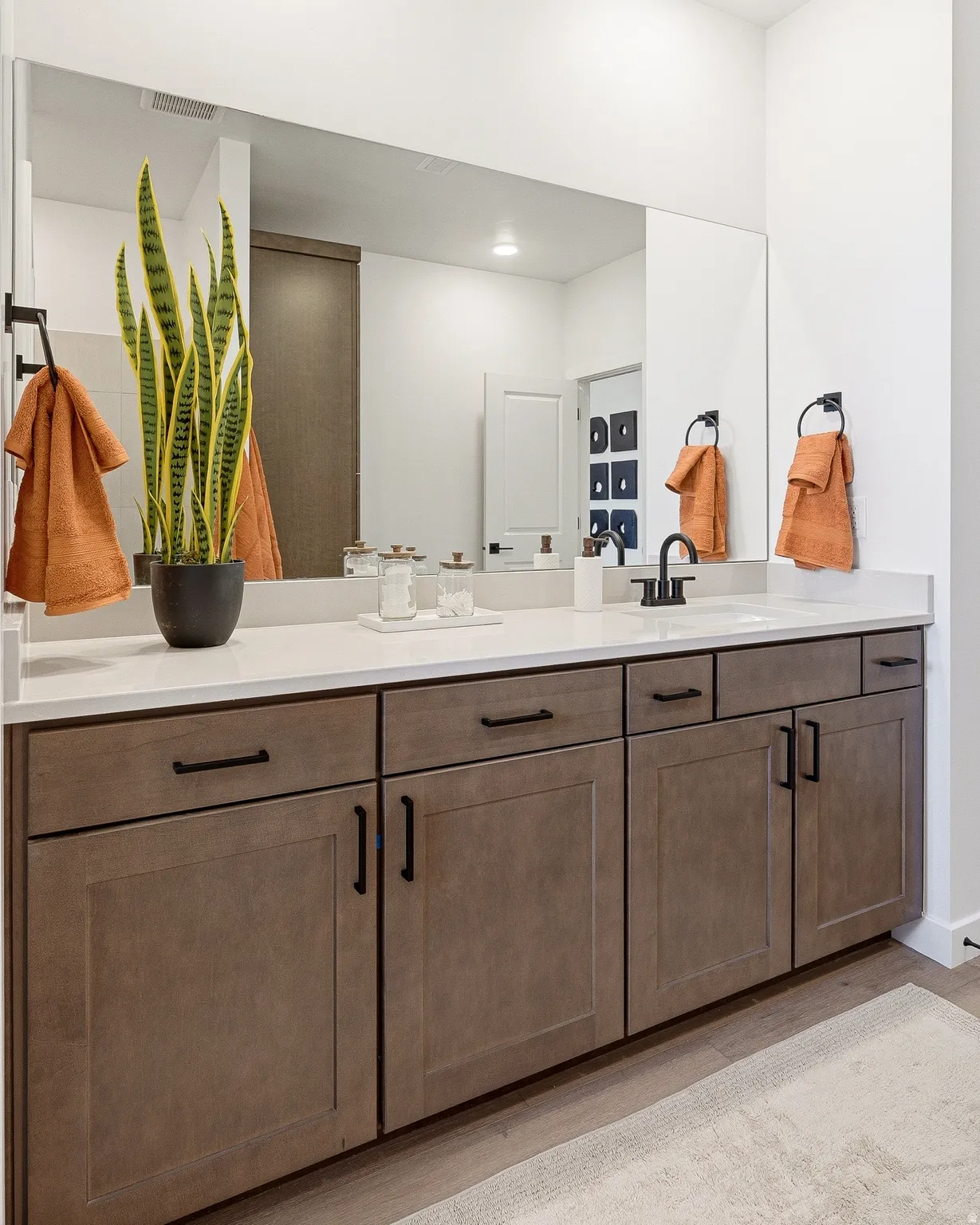 Bathroom with double vanity, light wood-type flooring, and recessed lighting