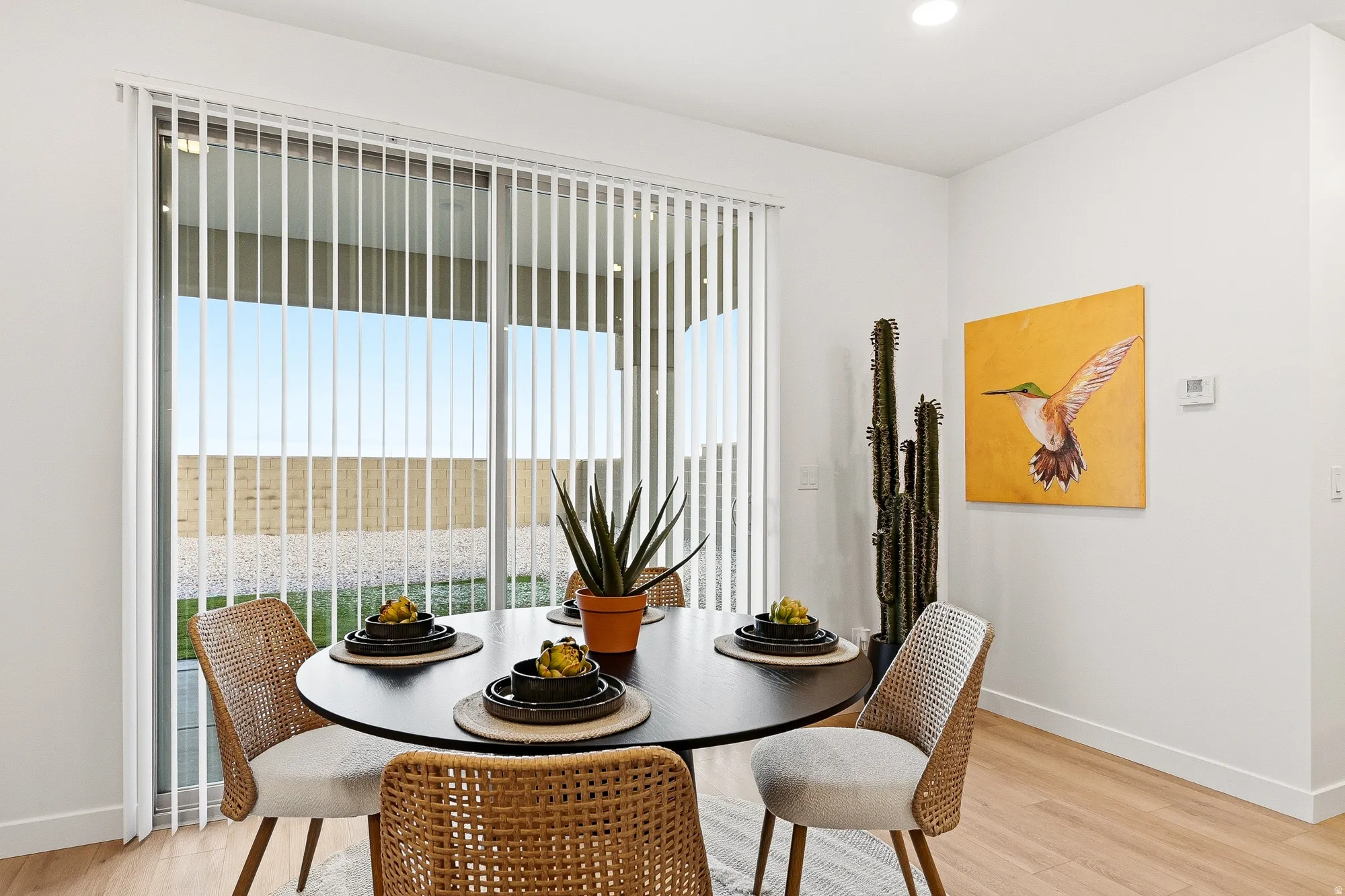 Dining space with light wood-style flooring and recessed lighting