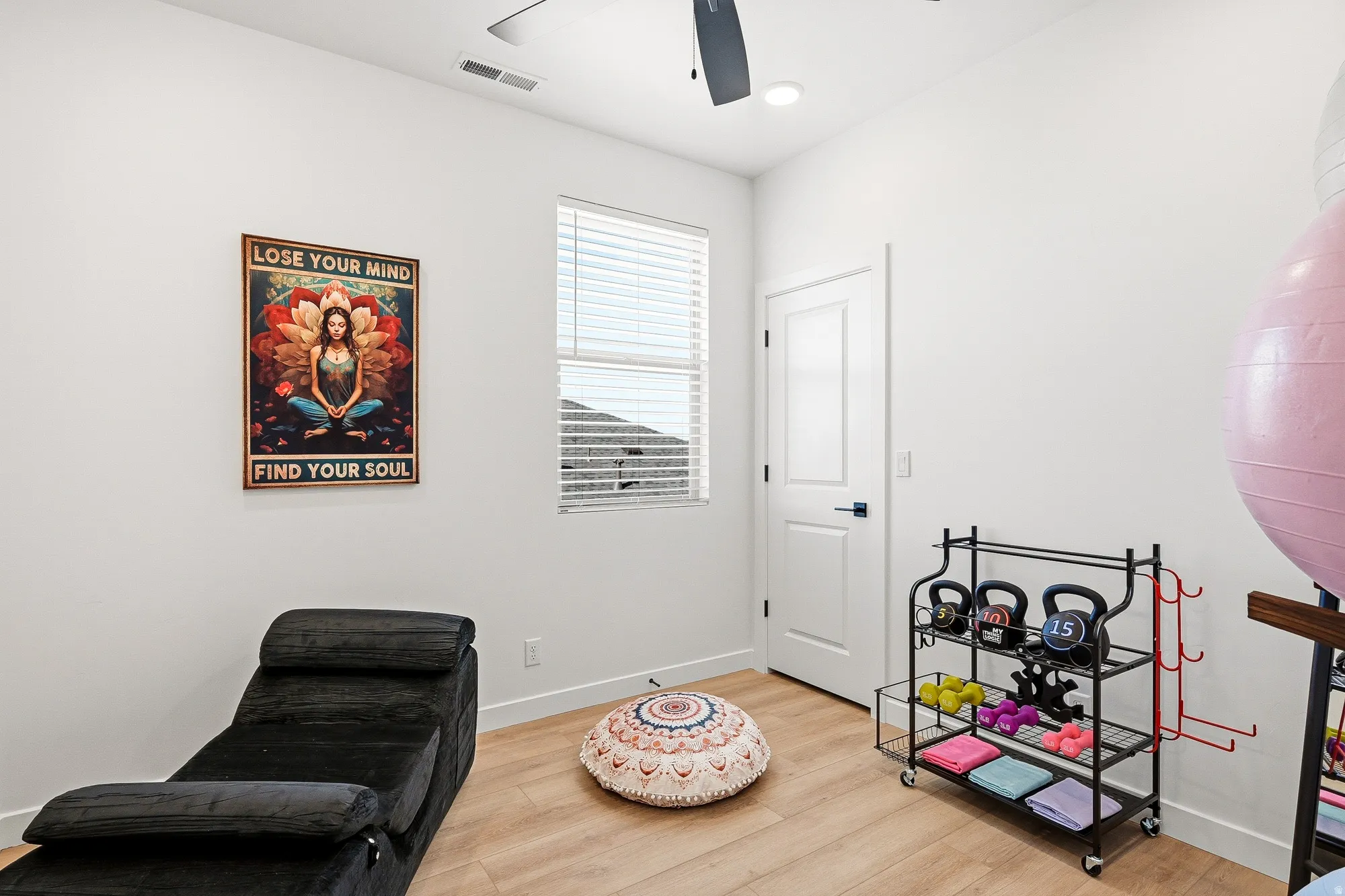 Living area with light wood-type flooring, a ceiling fan, and recessed lighting