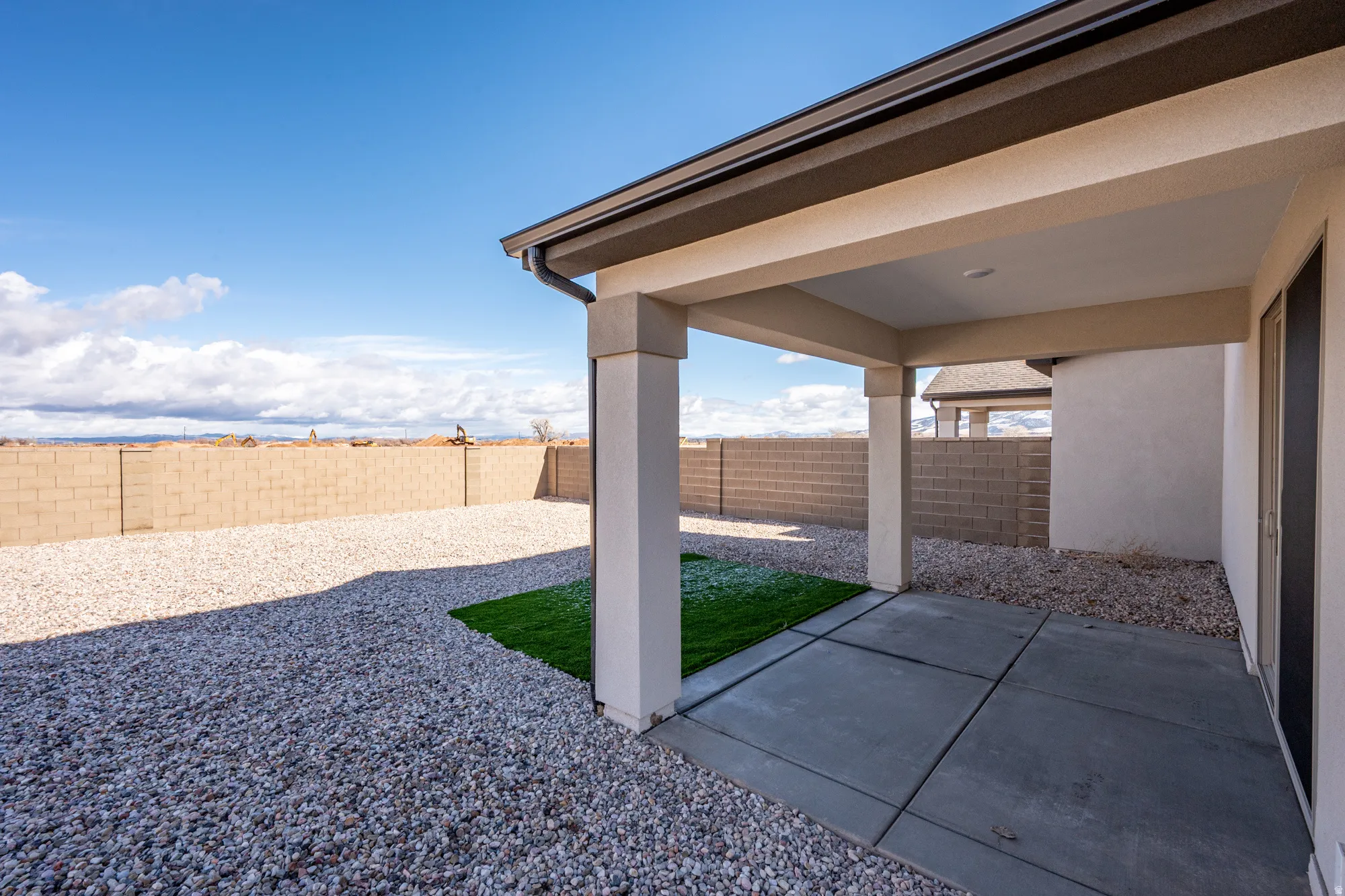 Fenced backyard with a patio area