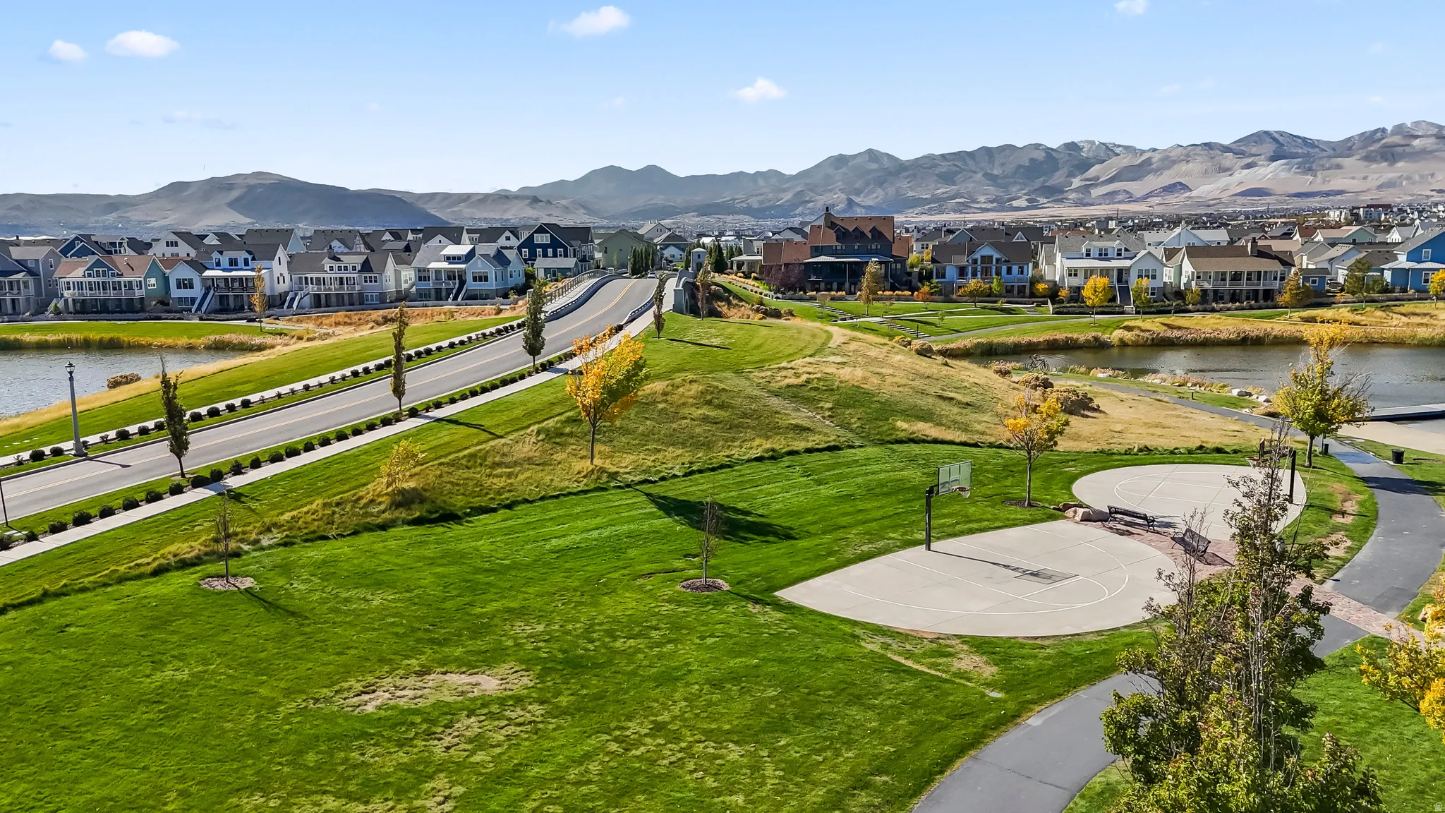 View of community with a water and mountain view, community basketball court, and a residential view