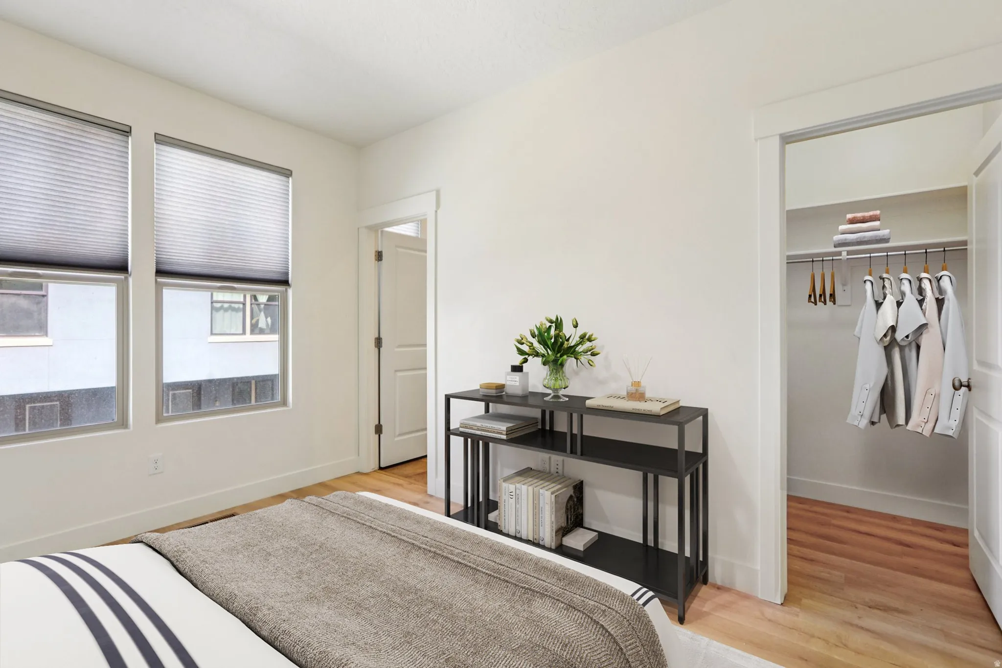 Bedroom featuring light wood-style floors and a spacious closet