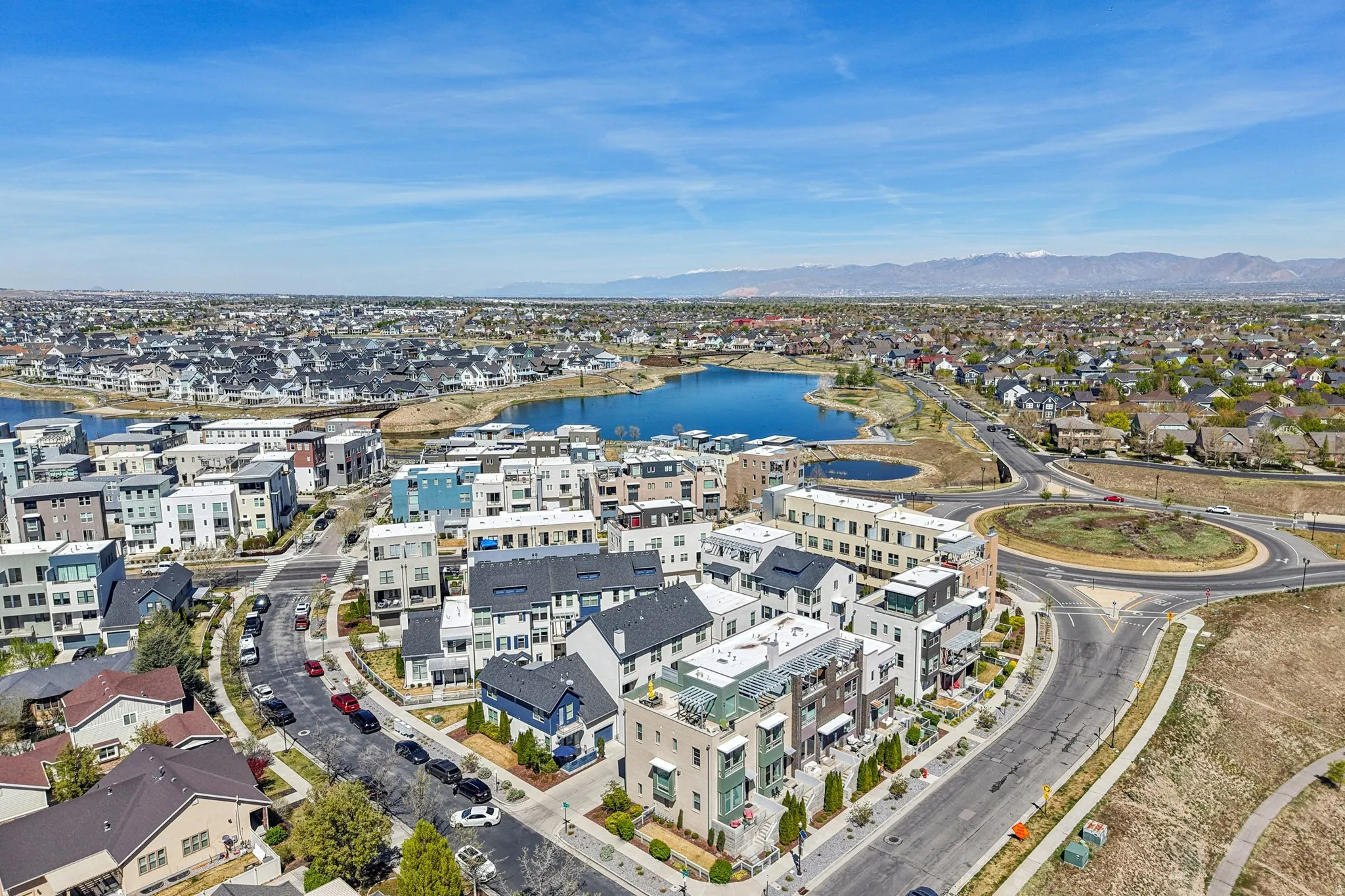 Aerial perspective of suburban area with a water and mountain view