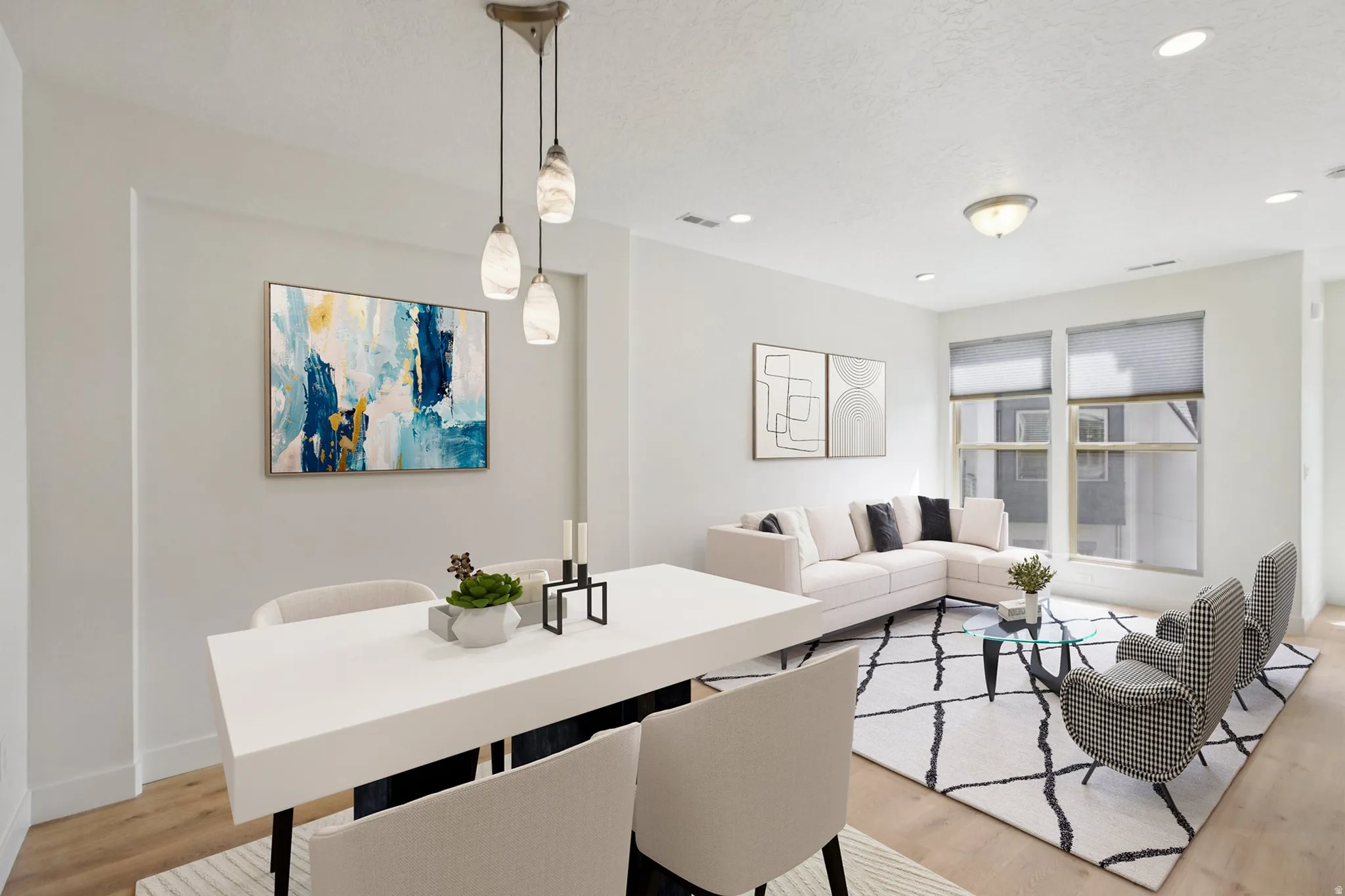 Dining area featuring light wood-type flooring, recessed lighting, and a textured ceiling