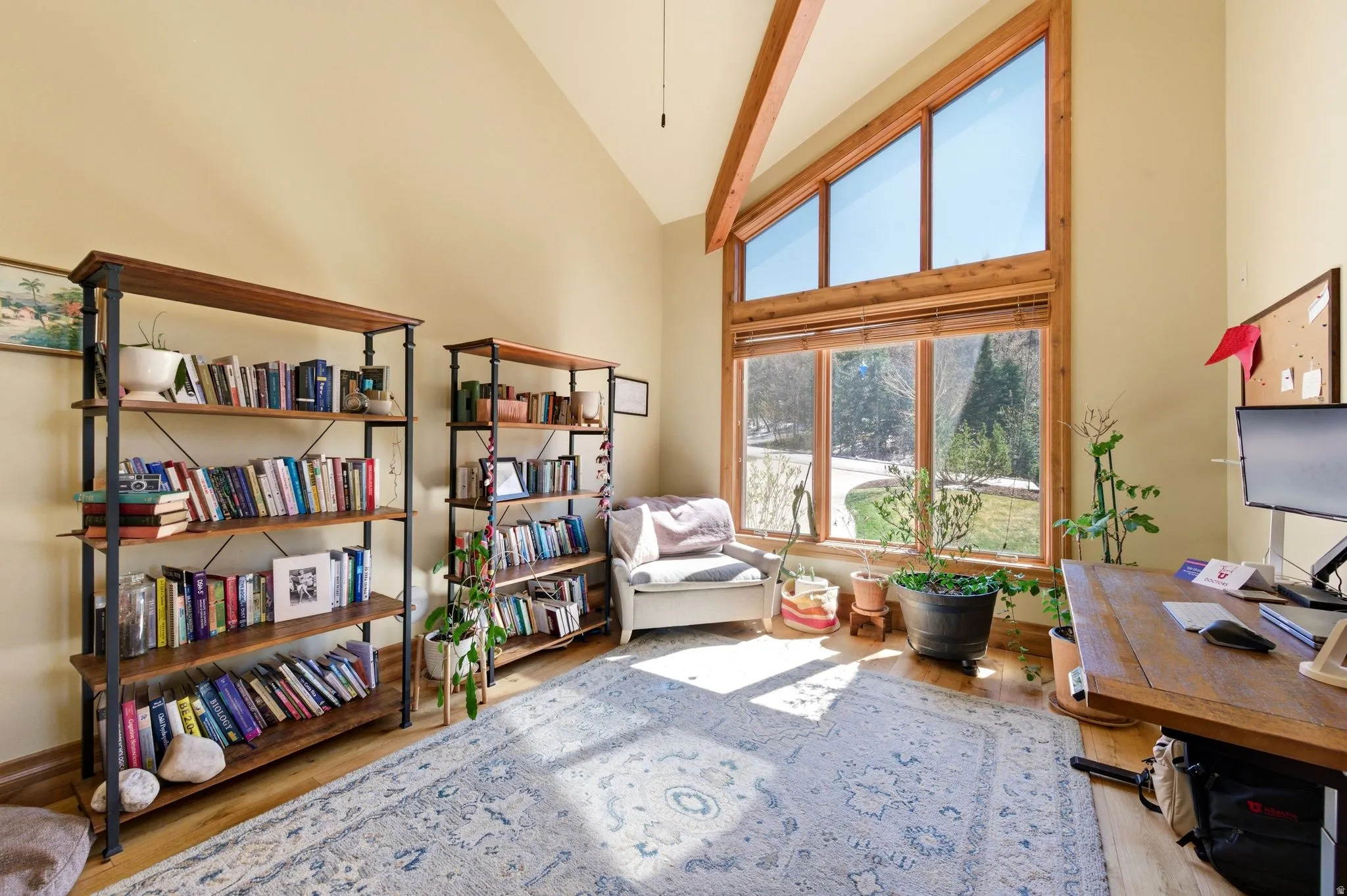 Office space with vaulted ceiling and light wood finished floors