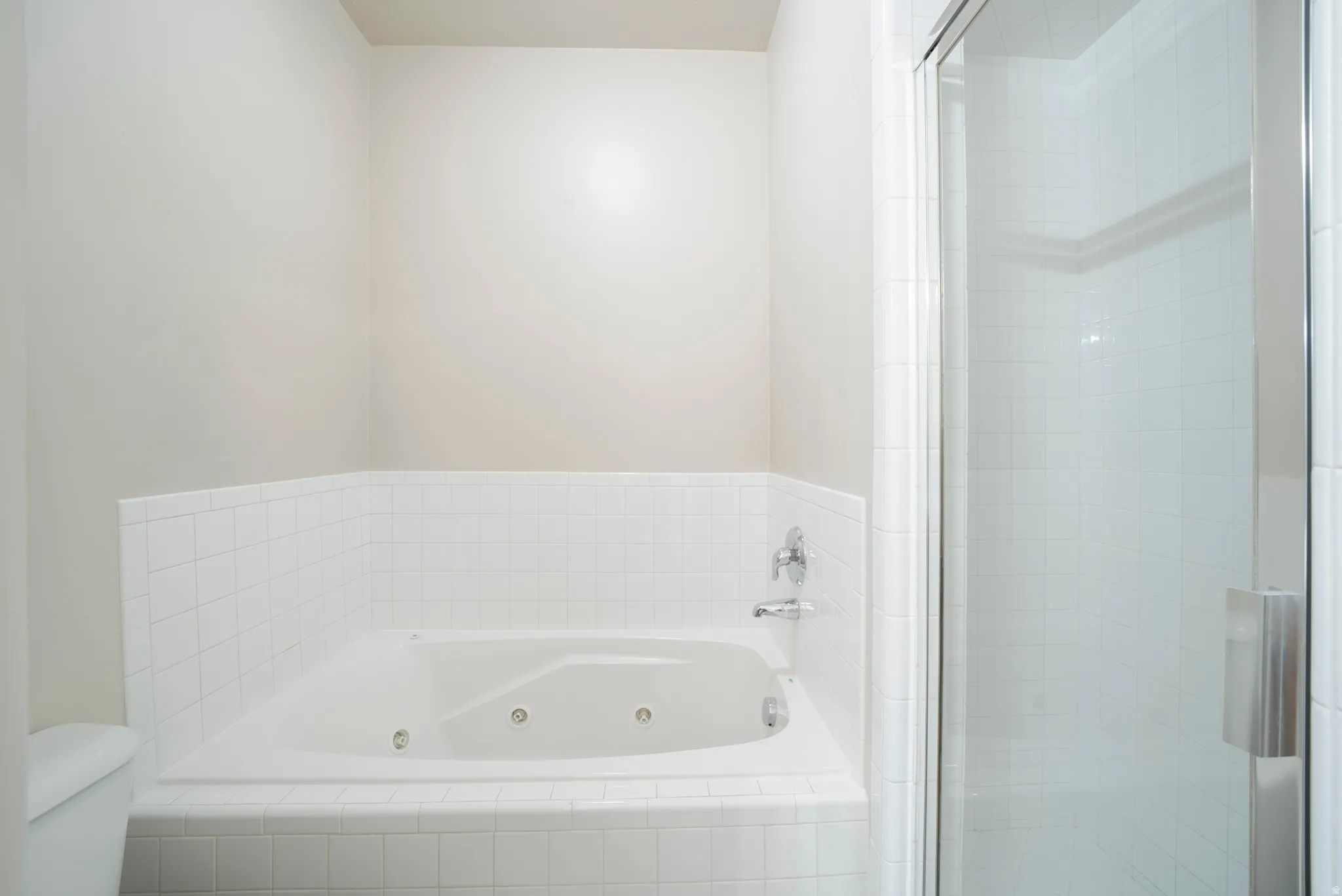 Full bath featuring a tub with jets and a shower stall