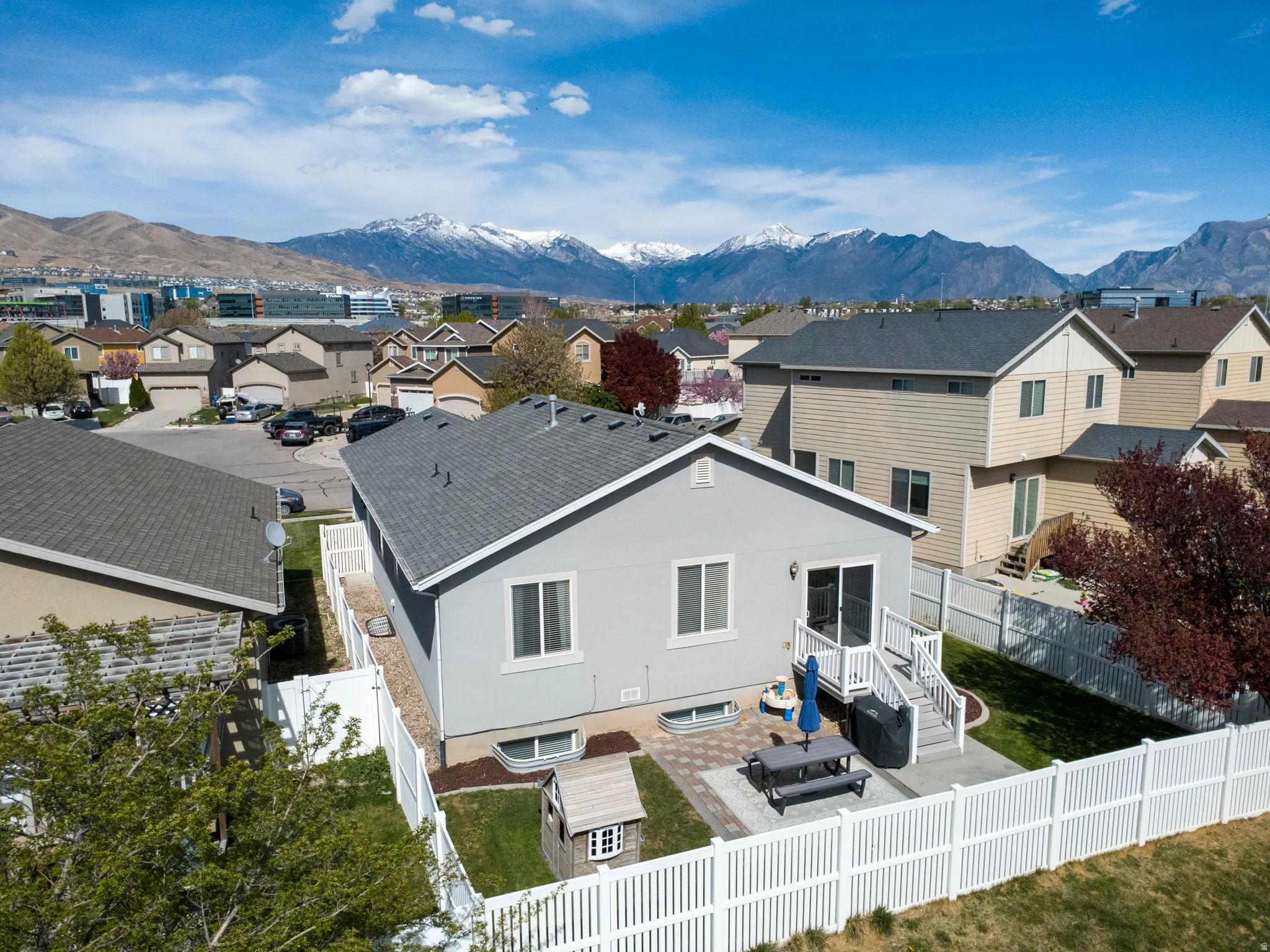 Back of house with a residential view, a patio, stucco siding, and a mountain view