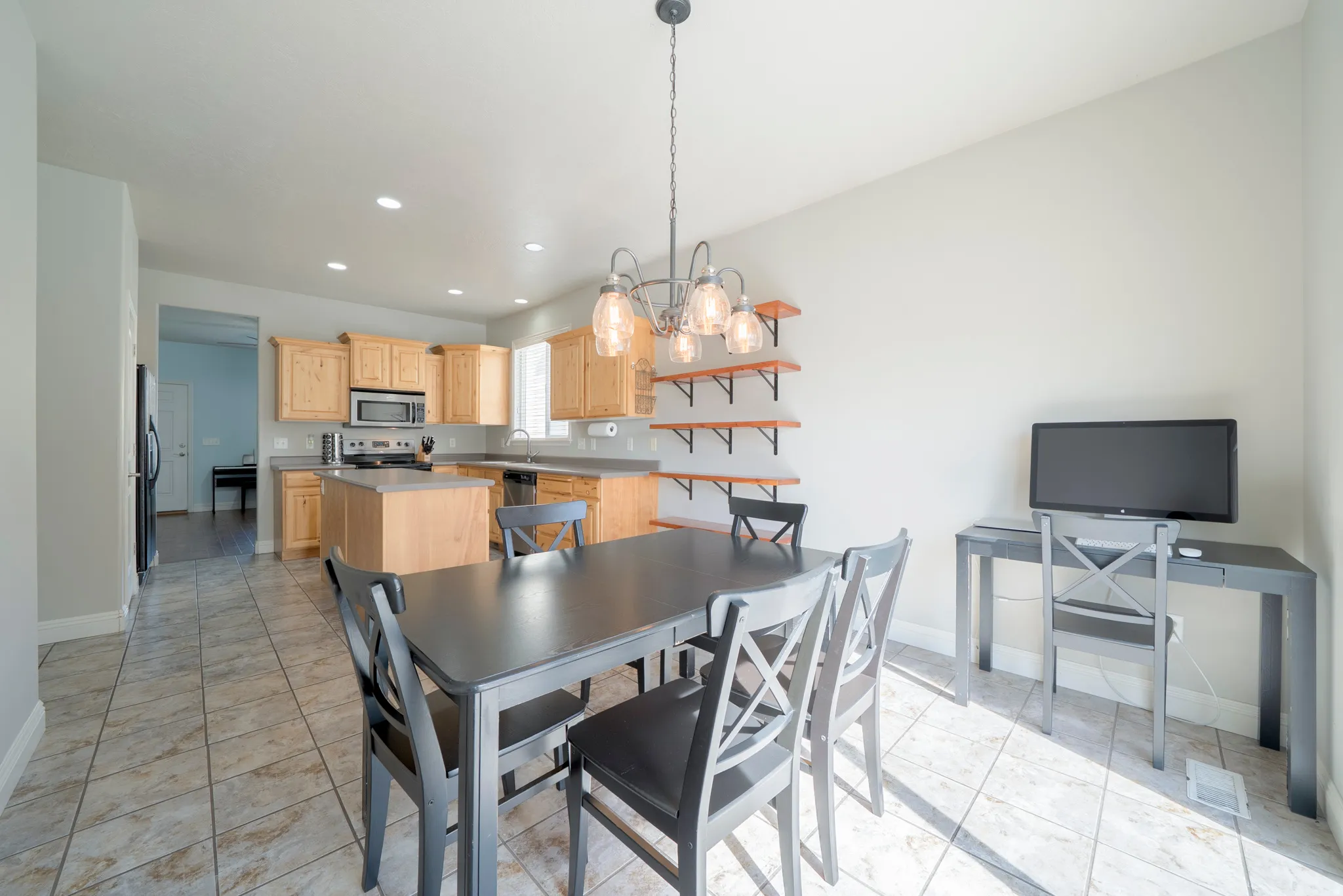 Dining room with suspended lighting and light tile patterned floors