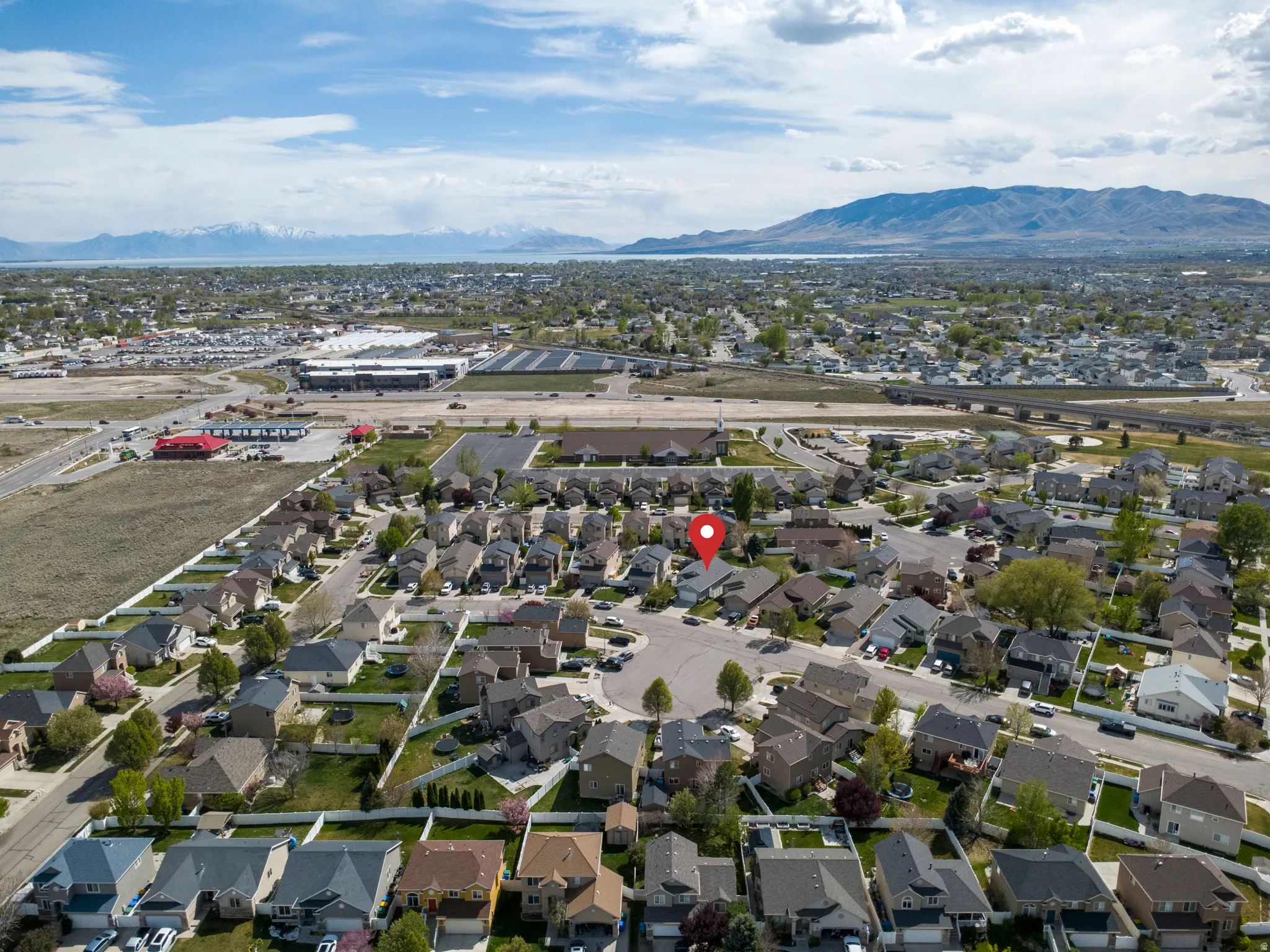 Aerial perspective of suburban area featuring a mountain backdrop