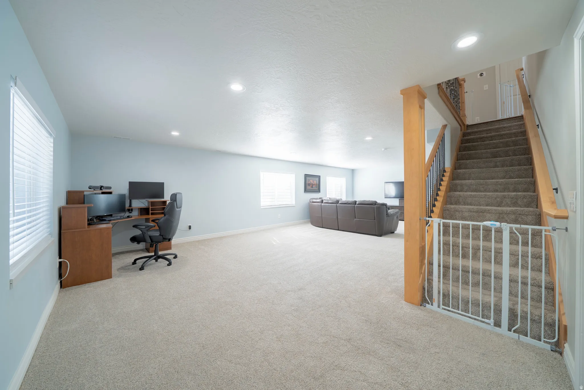 Home office with recessed lighting and light colored carpet