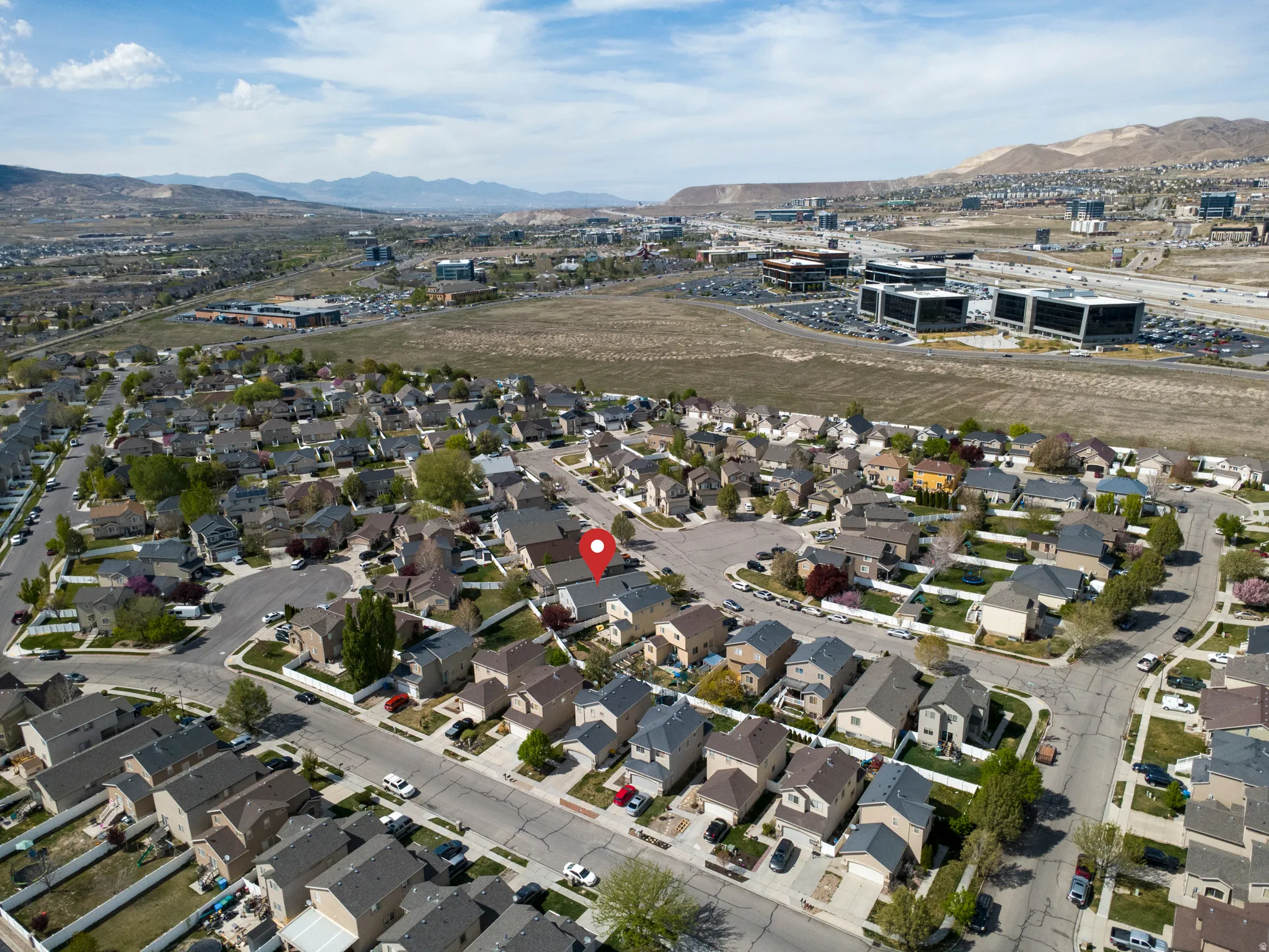 View of property location with a mountain backdrop and nearby suburban area