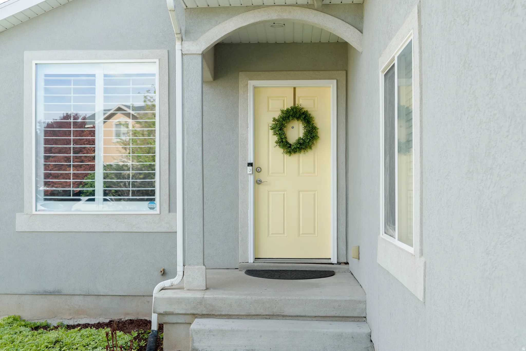 View of exterior entry featuring stucco siding