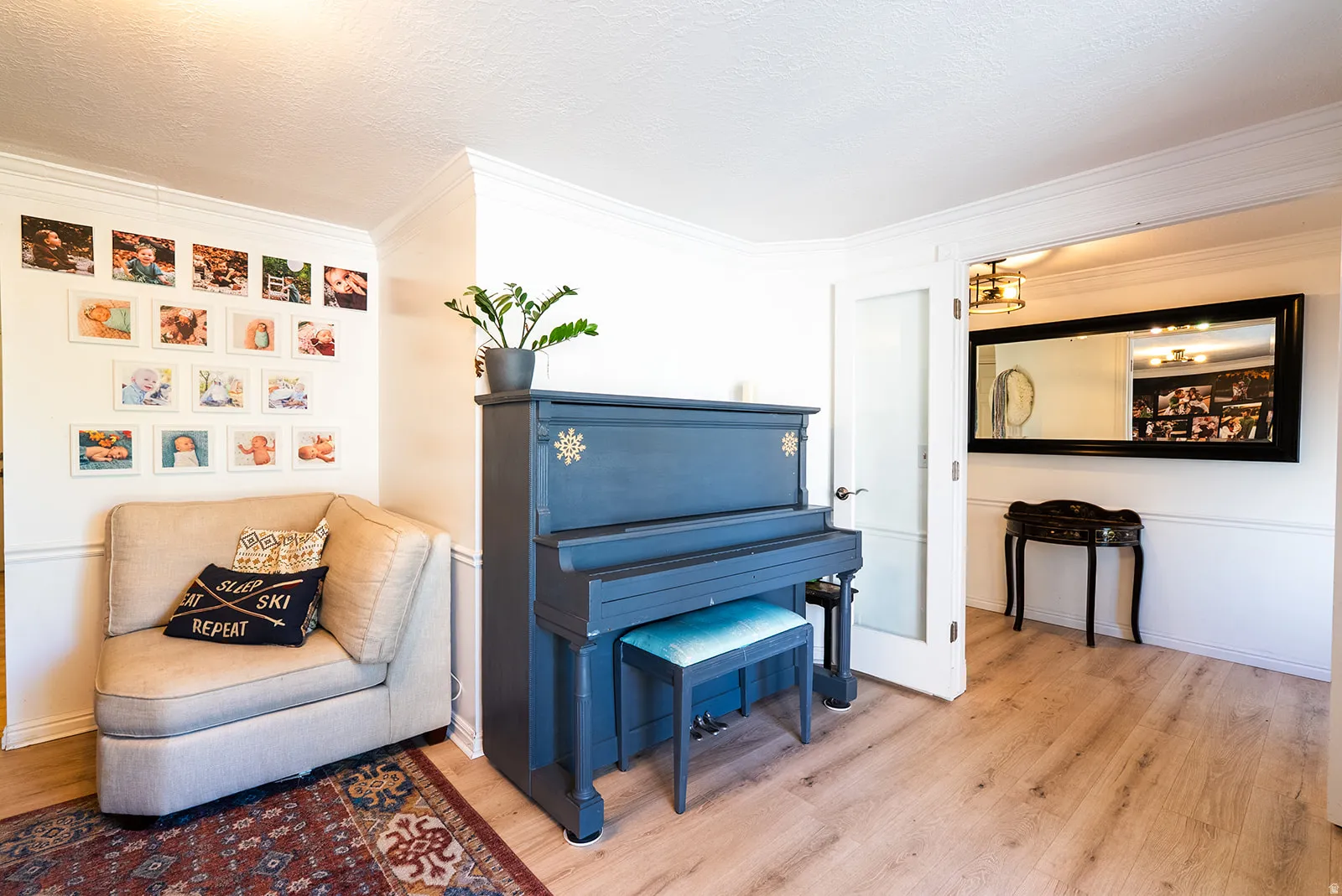 Sitting room featuring ornamental molding and light wood-style floors