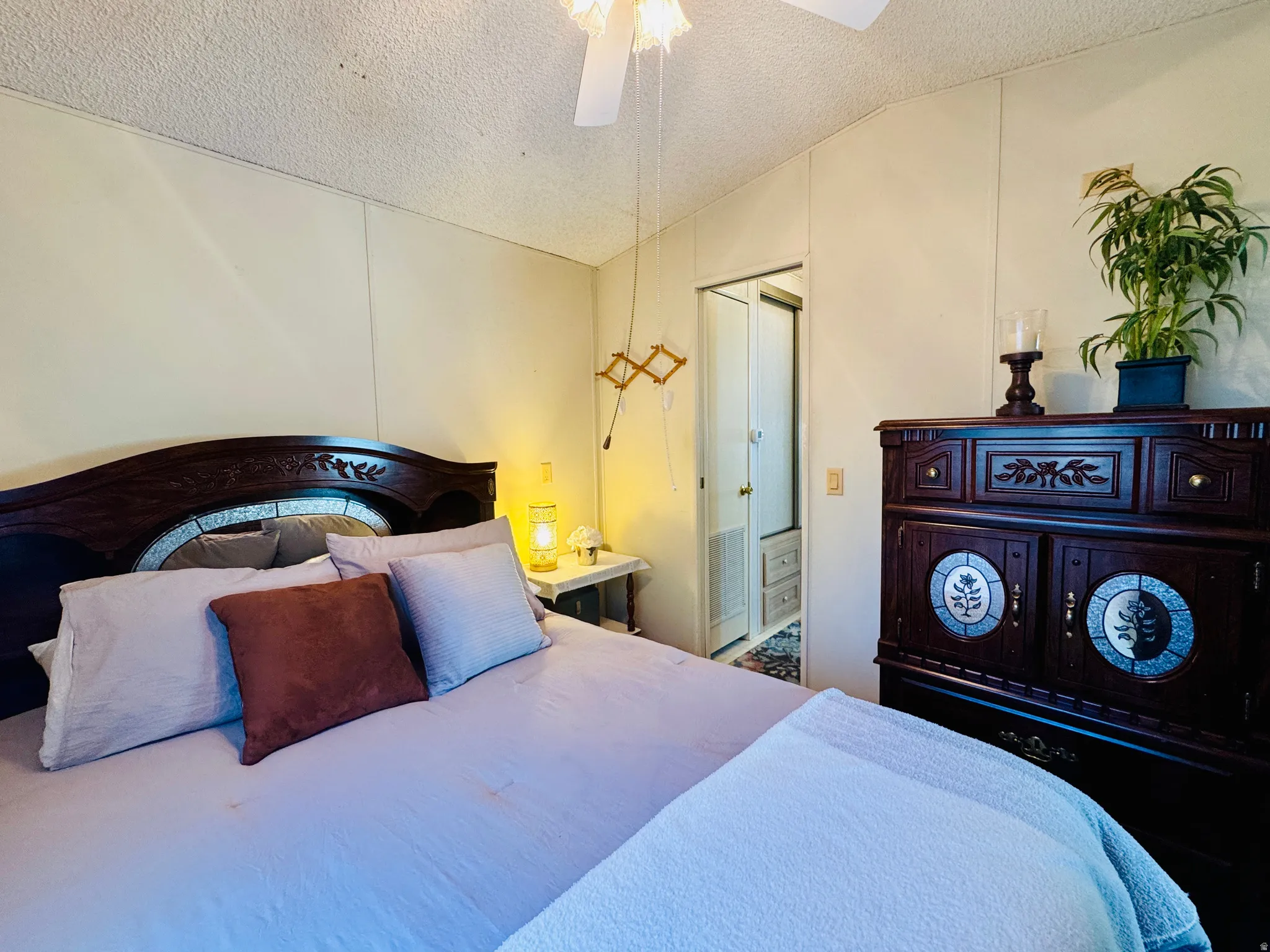 Bedroom featuring a textured ceiling and ceiling fan
