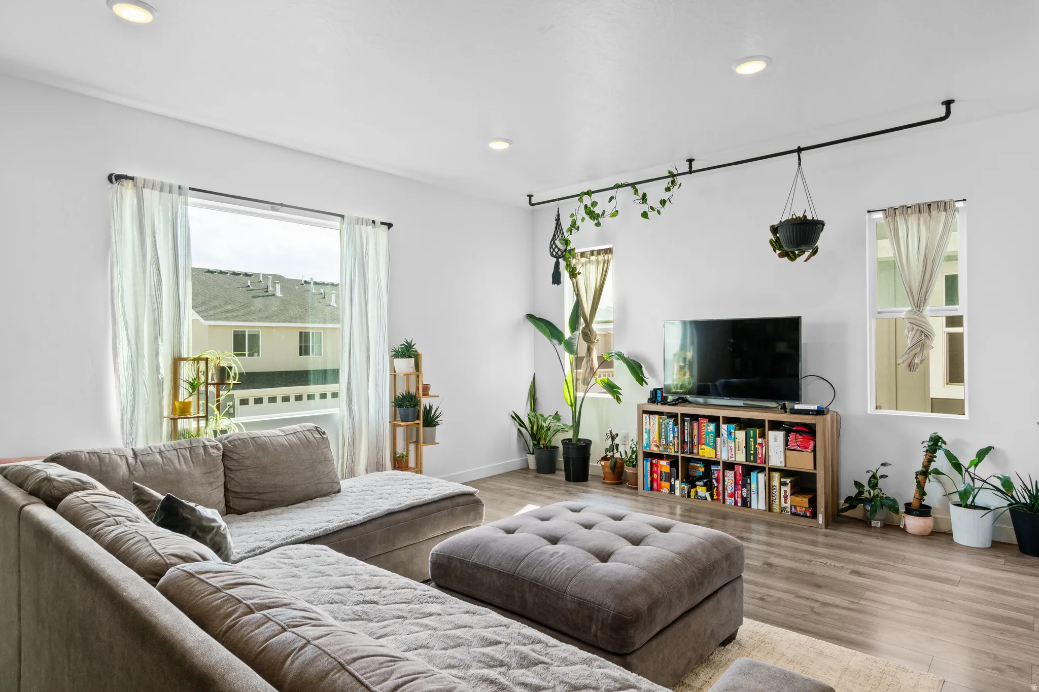 Living area featuring wood finished floors and recessed lighting