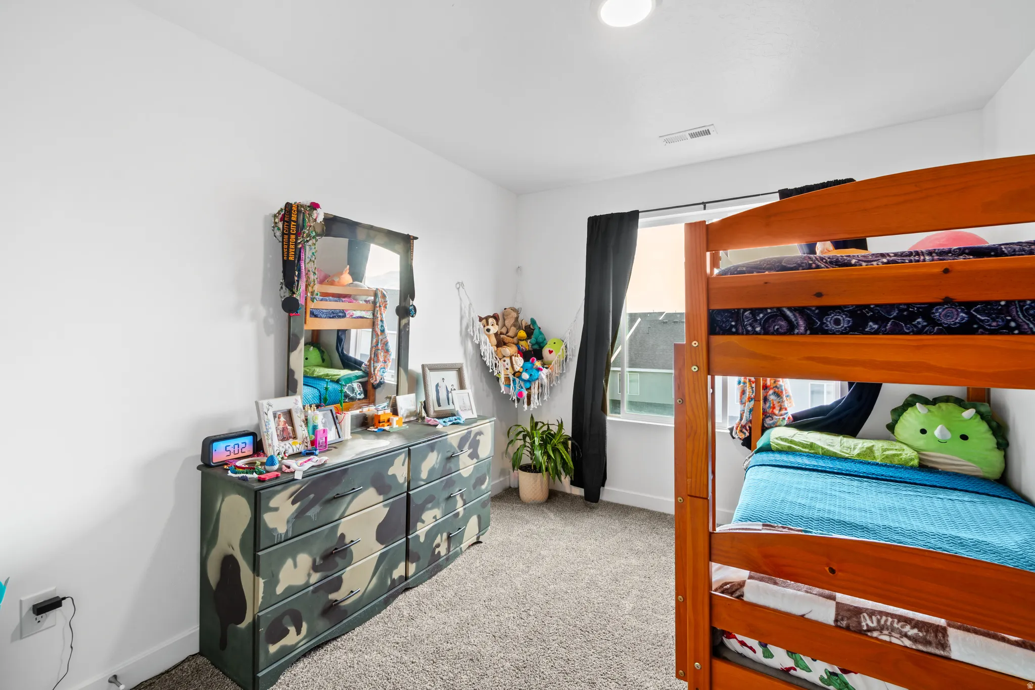 Bedroom featuring light colored carpet and baseboards