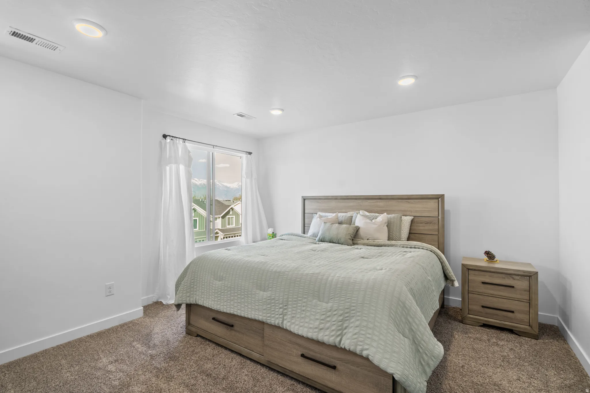 Bedroom featuring dark colored carpet