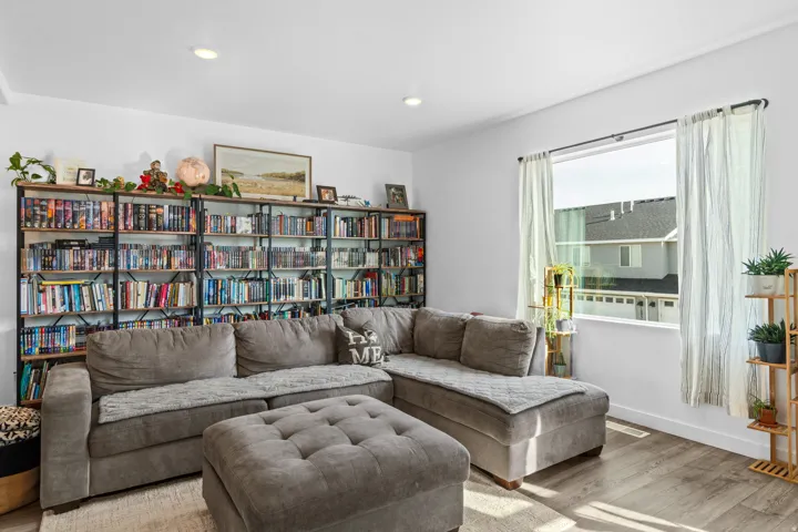 Living room with wood finished floors and recessed lighting