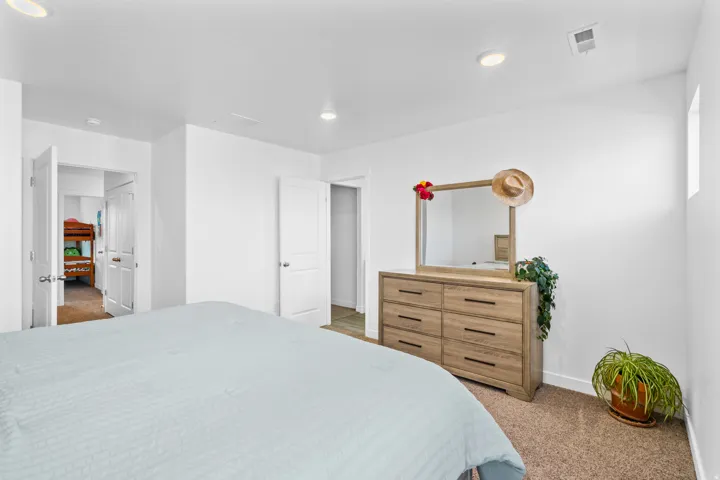 Bedroom with light carpet and baseboards