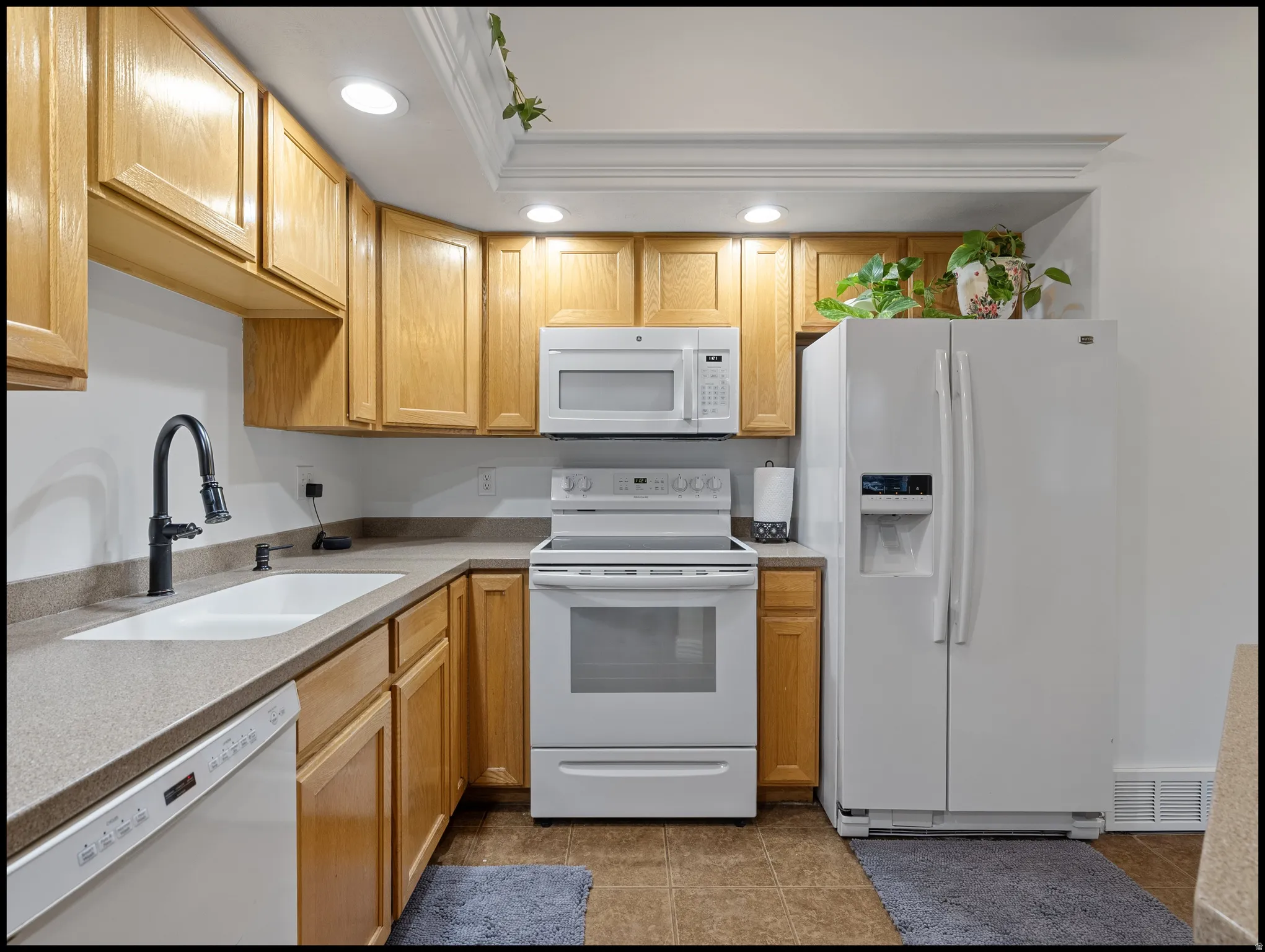 Kitchen featuring white appliances, recessed lighting