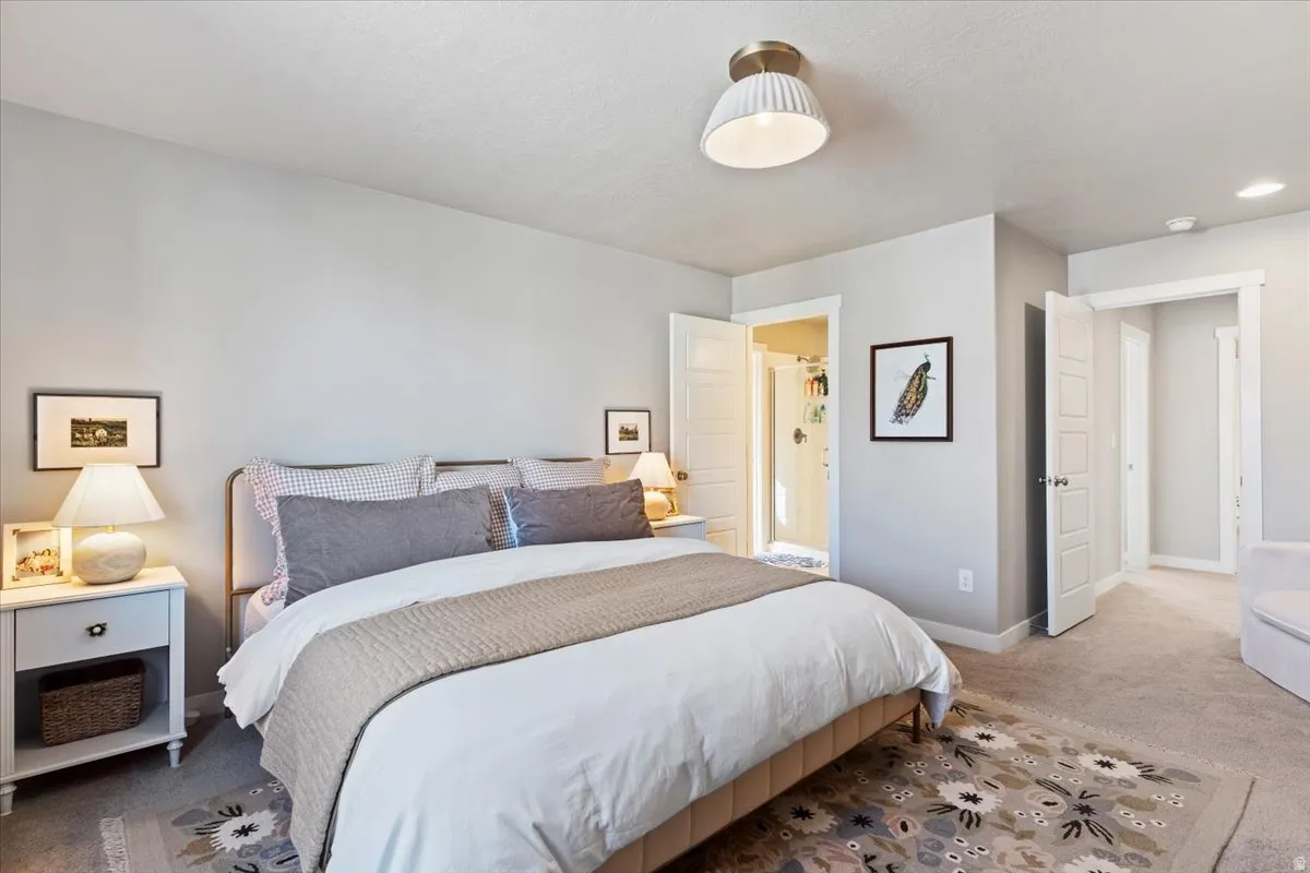 Bedroom featuring carpet floors and baseboards