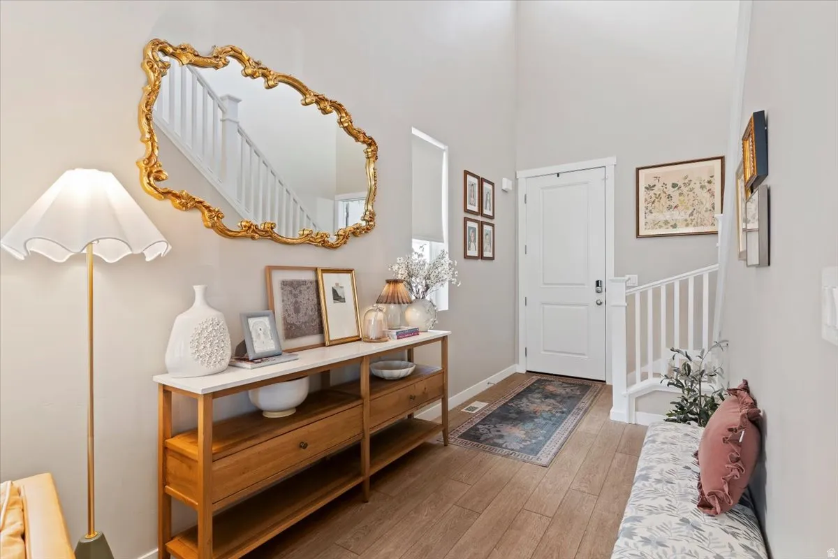Foyer featuring light wood-style flooring and a high ceiling
