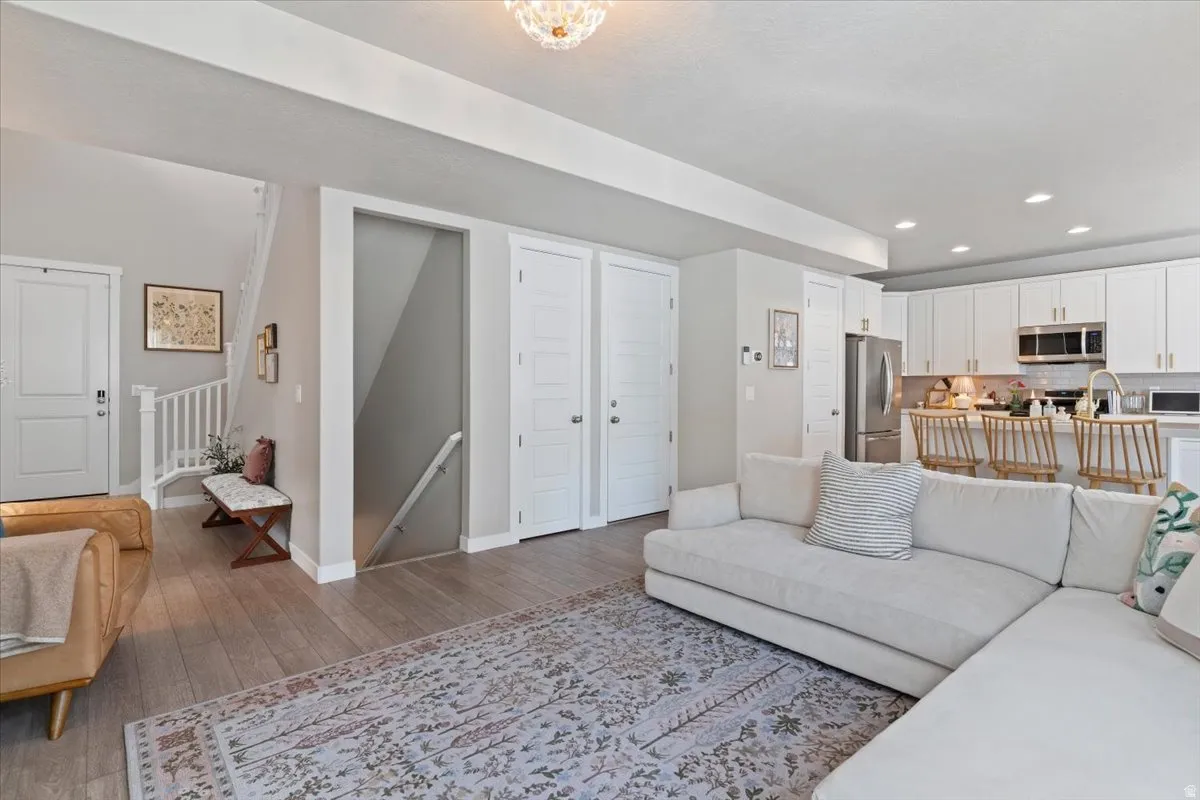 Living area featuring hardwood / wood-style flooring and recessed lighting