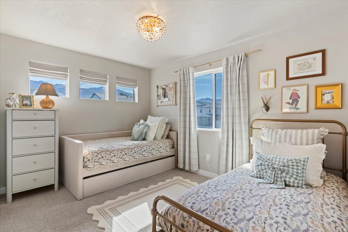 Bedroom with light carpet and baseboards