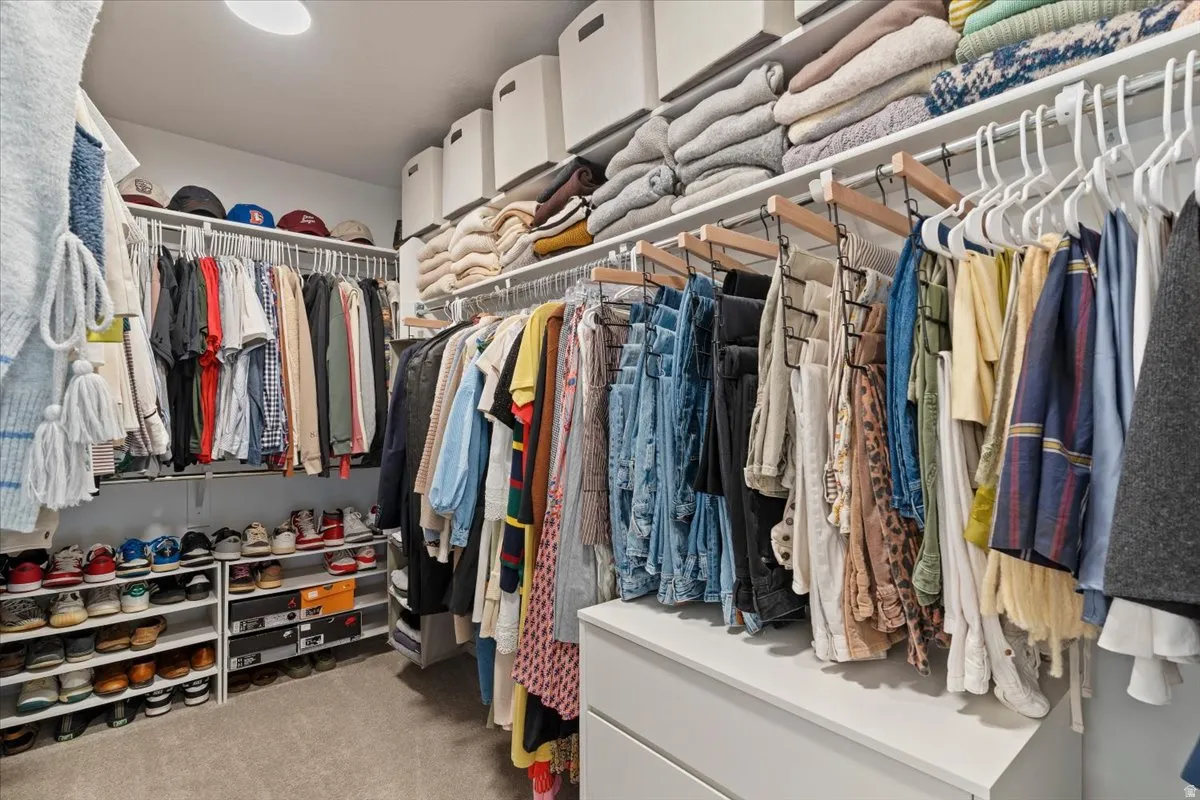 Walk in closet with light carpet