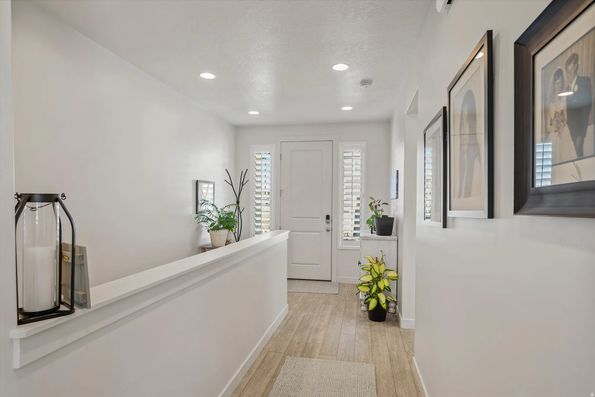 Hallway featuring light wood finished floors and recessed lighting