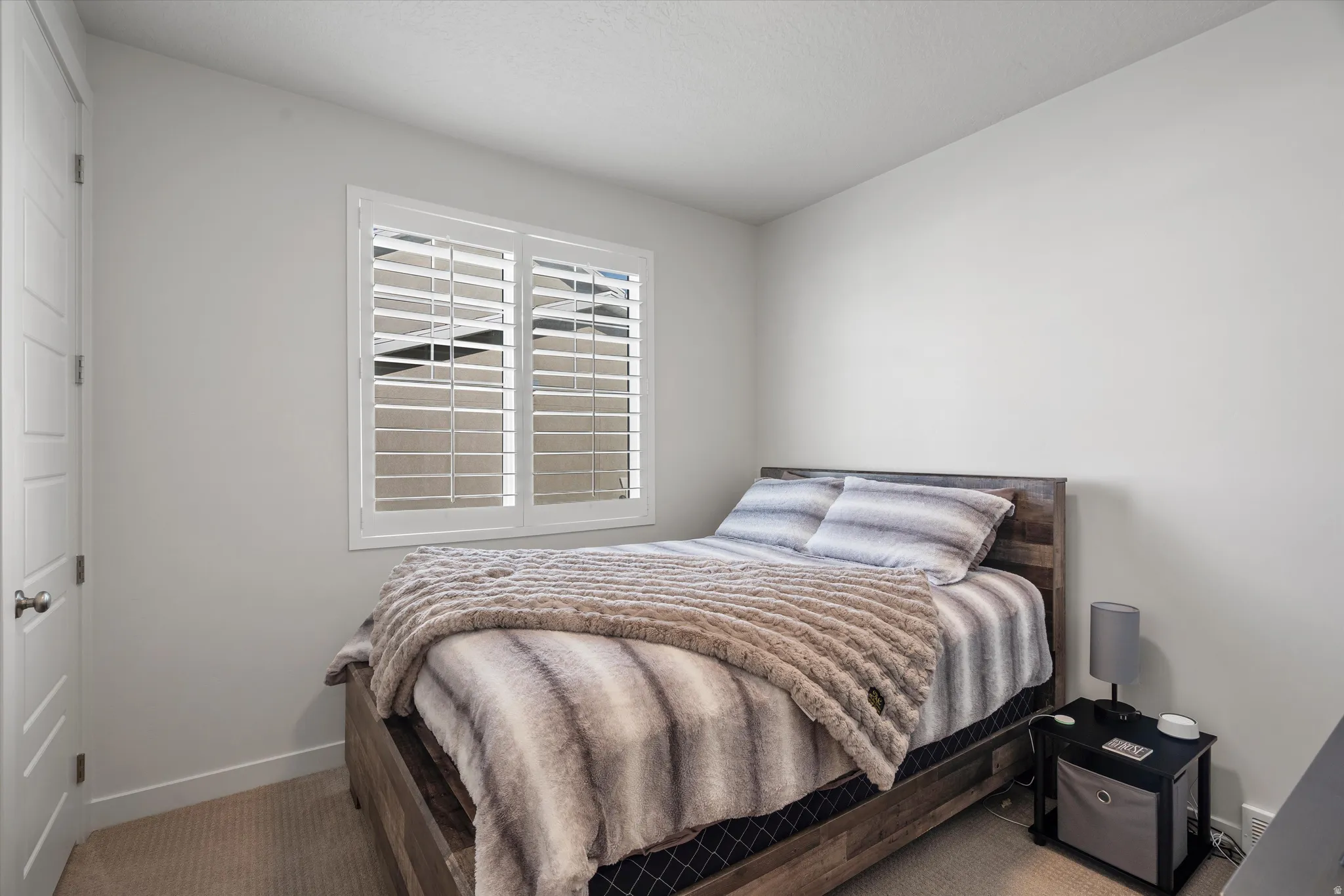 Carpeted bedroom featuring baseboards